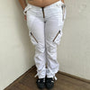 Woman Dressed in Y2K 00s white low-rise cargo pants, classic cargo pocket detailing and strap details.