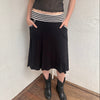 Woman wearing a Y2K 00s black & white stripe waistband midi skirt with stripe pockets