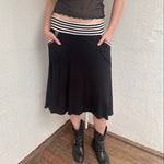 Woman wearing a Y2K 00s black & white stripe waistband midi skirt with stripe pockets