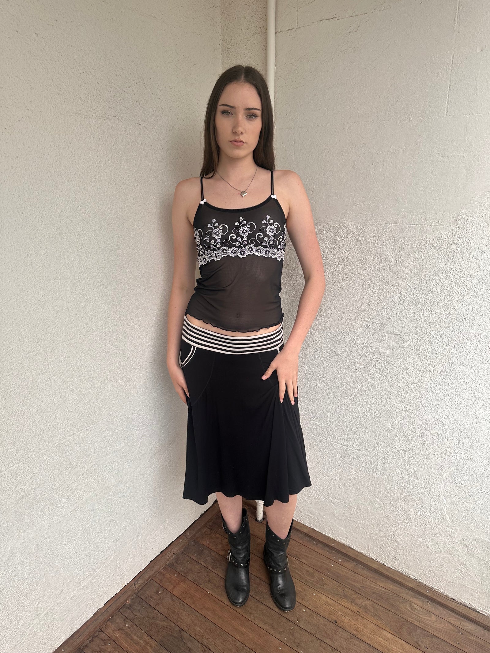 Woman wearing a Y2K 00s black & white stripe waistband midi skirt with stripe pockets