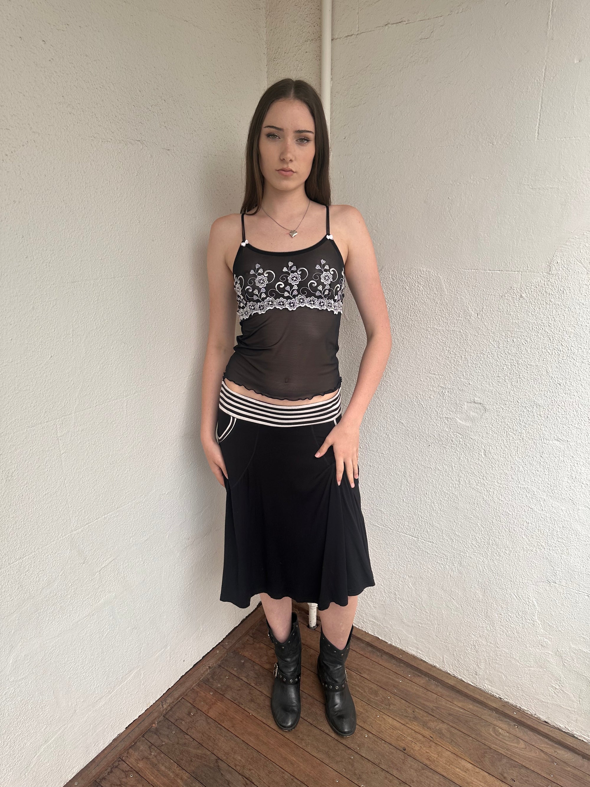 Woman wearing a Y2K 00s black & white stripe waistband midi skirt with stripe pockets