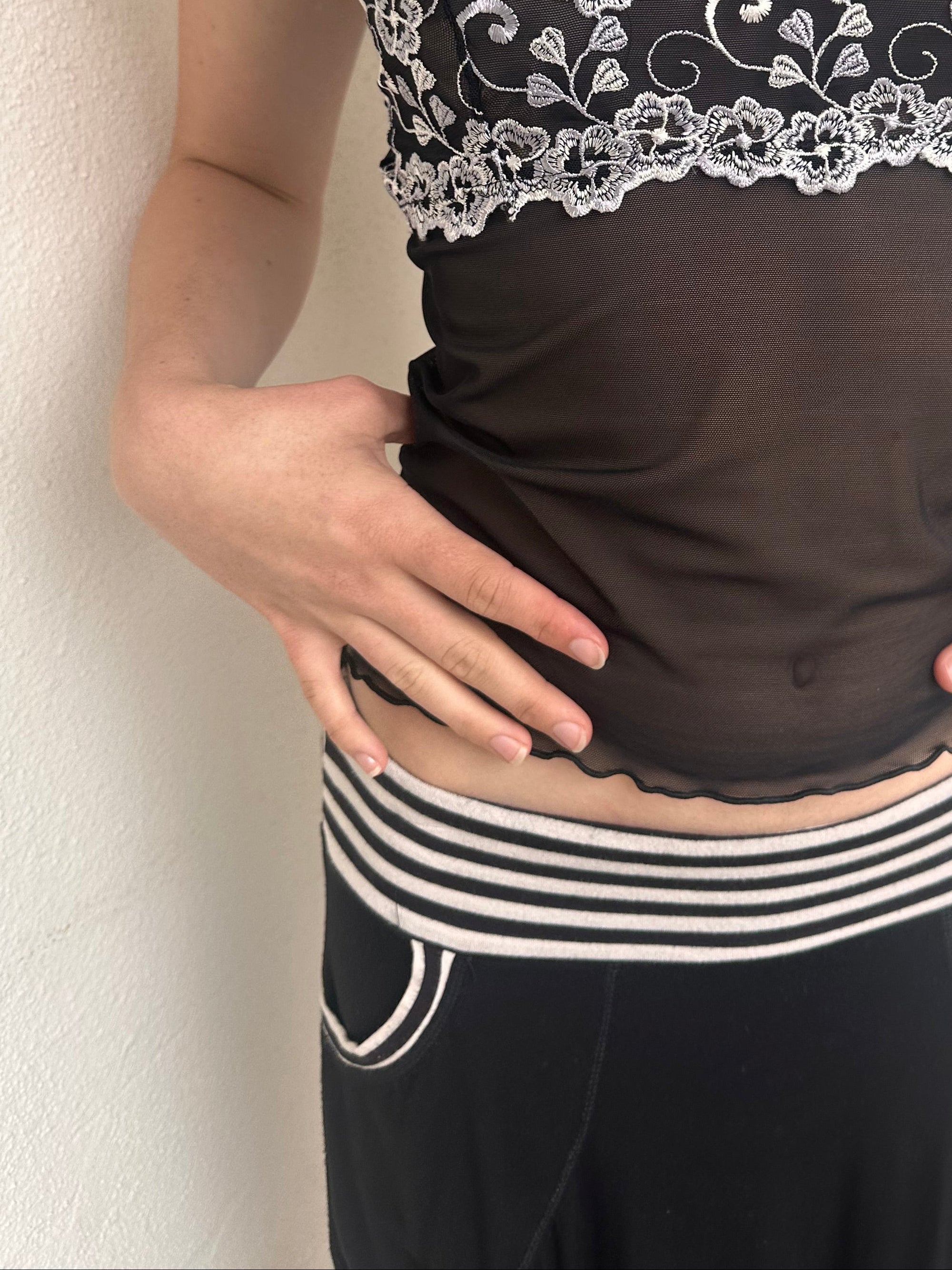 Woman wearing a Y2K 00s black & white stripe waistband midi skirt with stripe pockets detail shot
