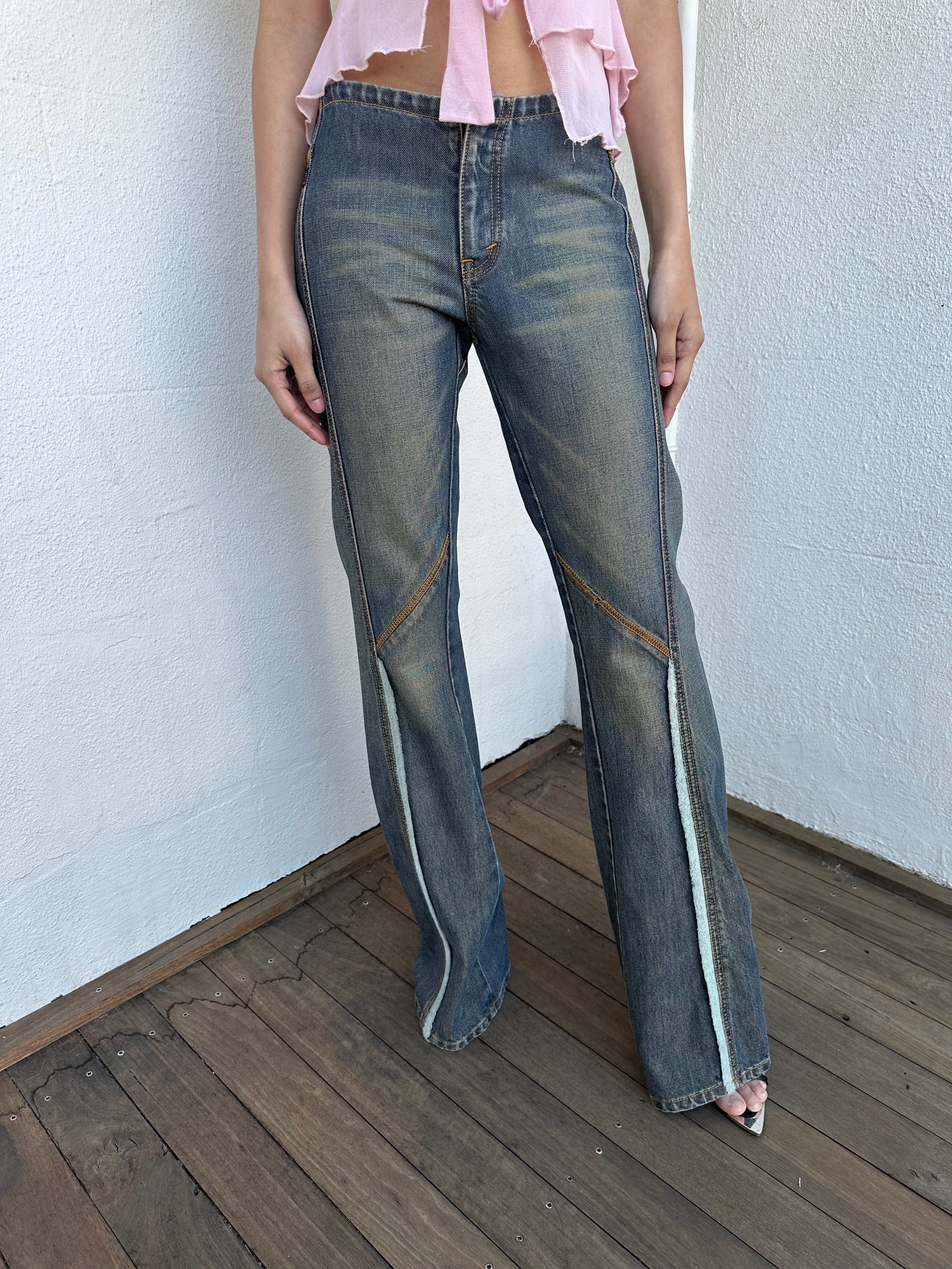 Woman wearing a Y2K 00s Ralph Lauren collab Chaps Jeans warm wash low rise flared 