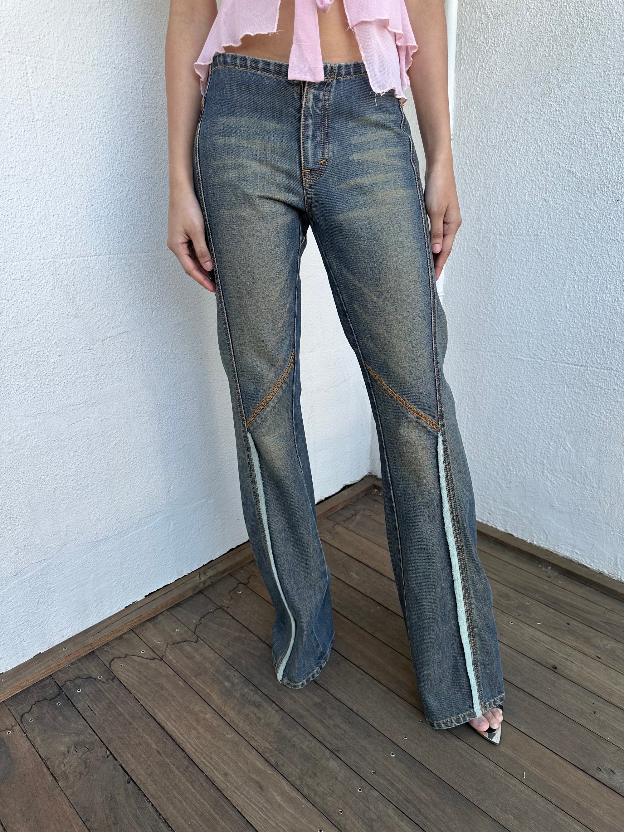 Woman wearing a Y2K 00s Ralph Lauren collab Chaps Jeans warm wash low rise flared 