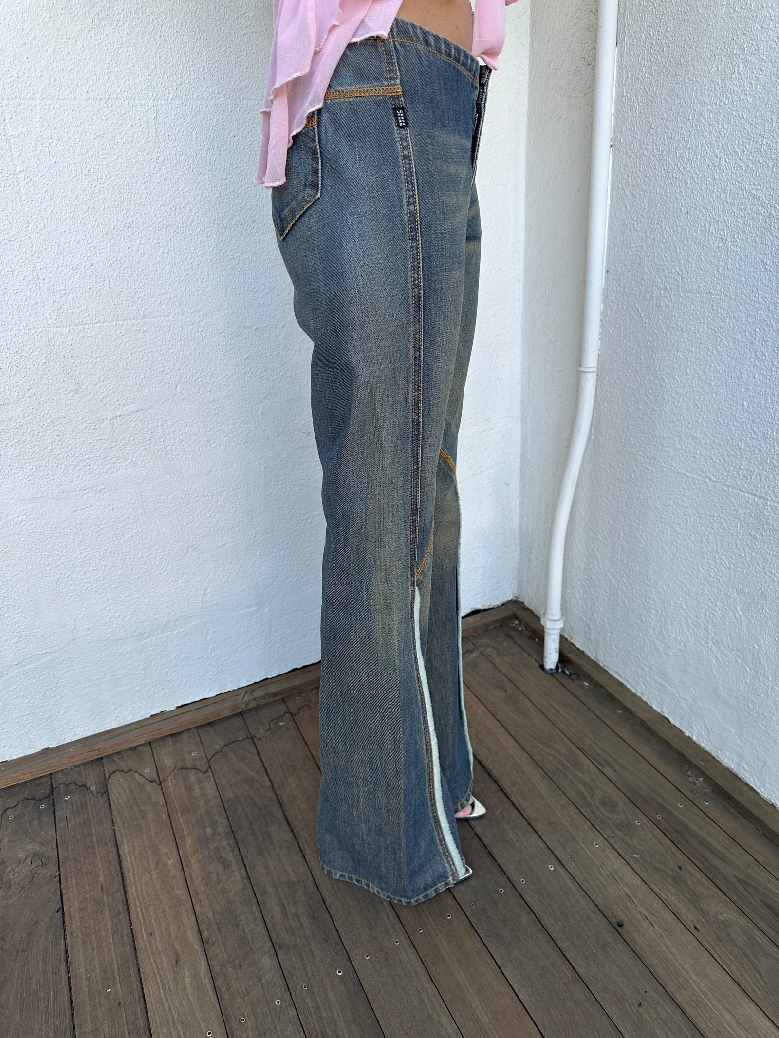 Woman wearing a Y2K 00s Ralph Lauren collab Chaps Jeans warm wash low rise flared 