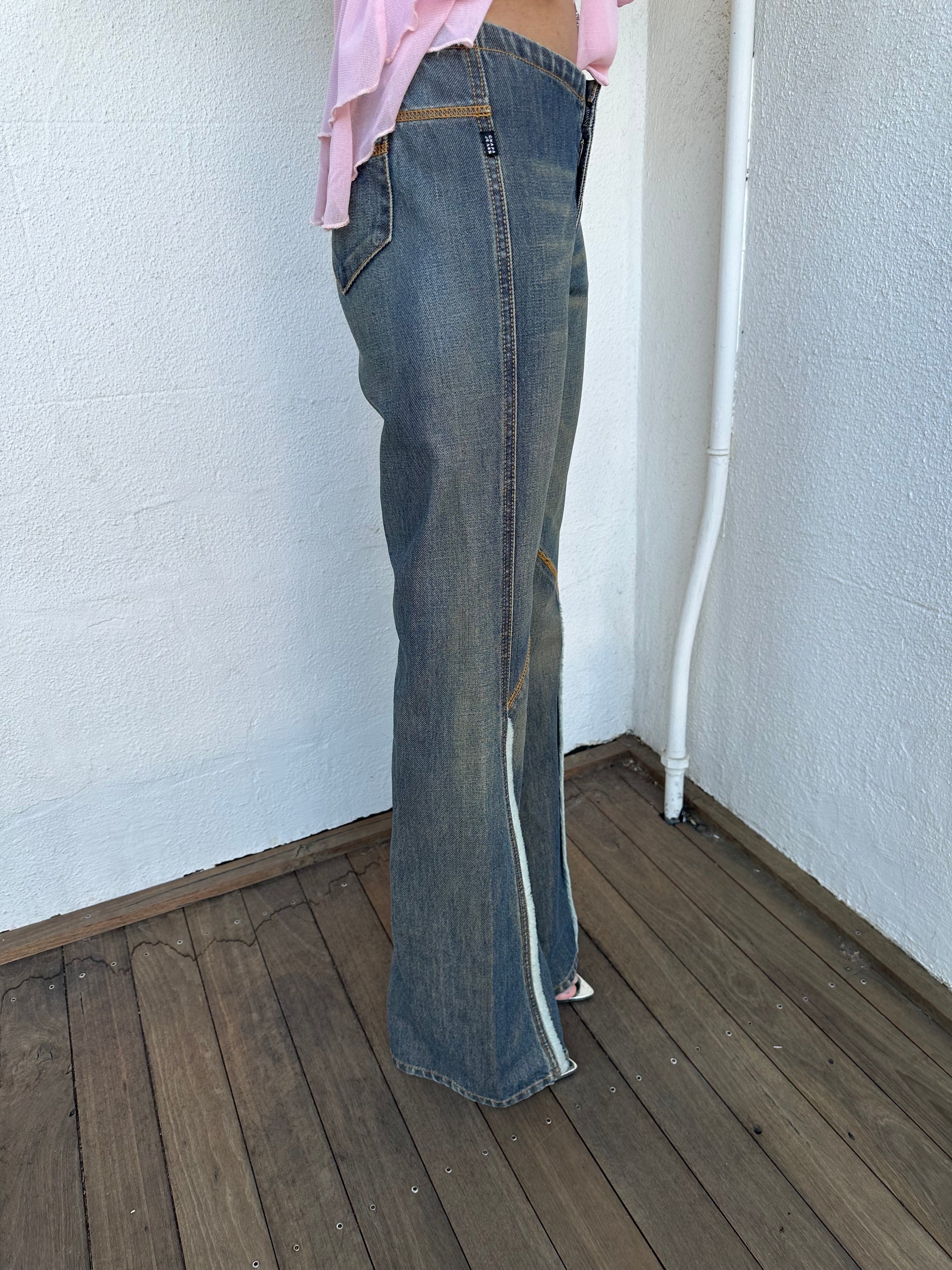 Woman wearing a Y2K 00s Ralph Lauren collab Chaps Jeans warm wash low rise flared 