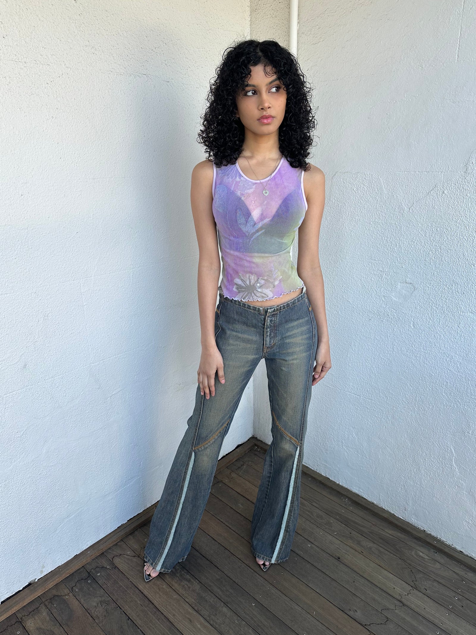 Woman wearing a Y2K 00s Ralph Lauren collab Chaps Jeans warm wash low rise flared 