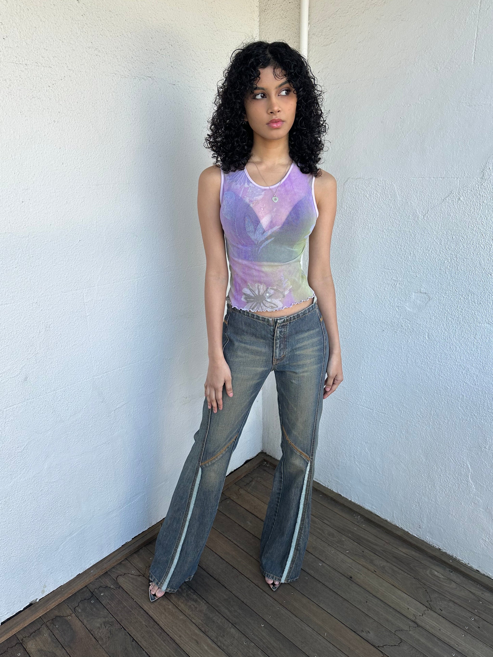 Woman wearing a Y2K 00s Ralph Lauren collab Chaps Jeans warm wash low rise flared 