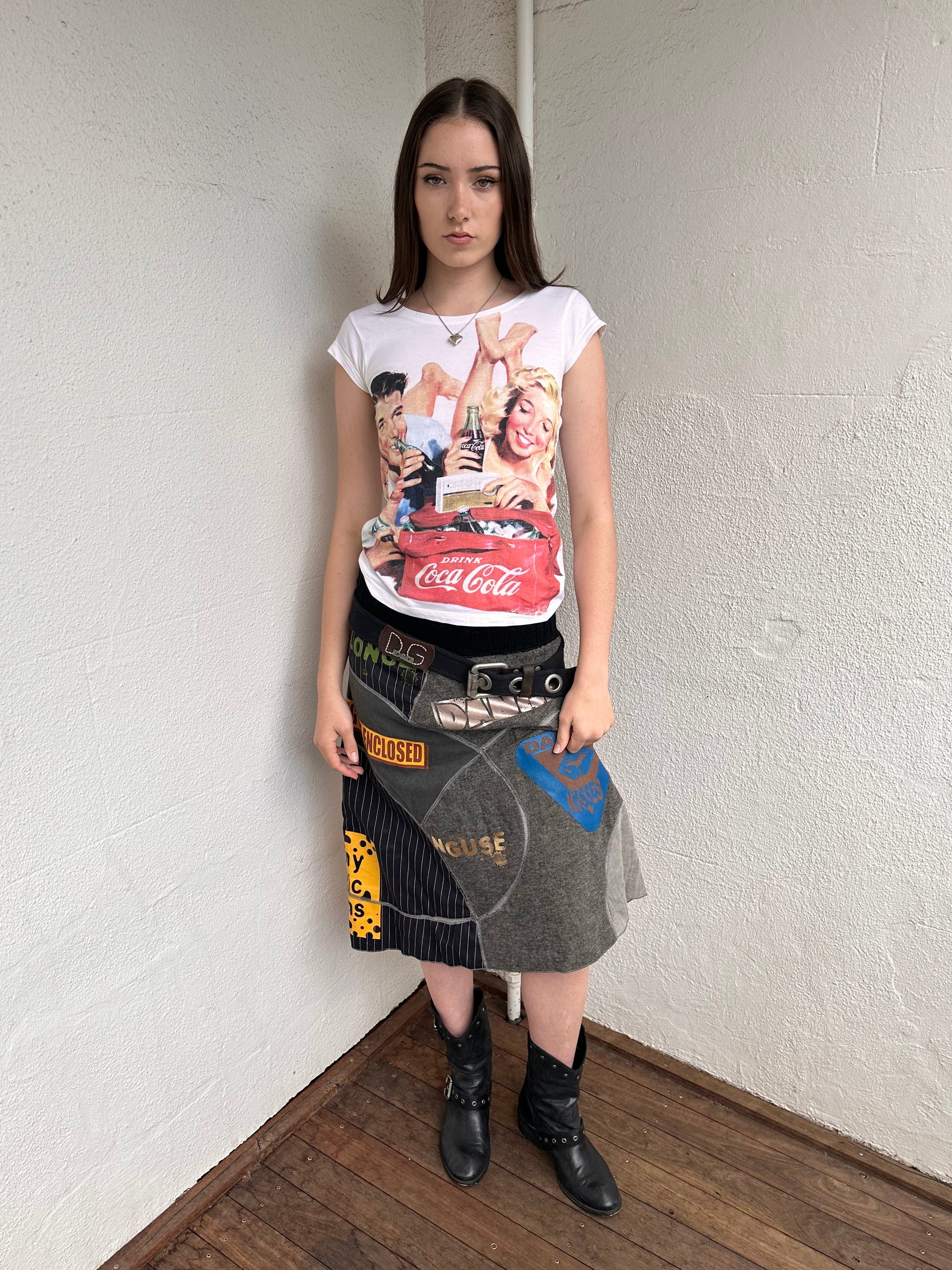 Woman wearing a Y2K 00s Coca Cola family print T-shirt