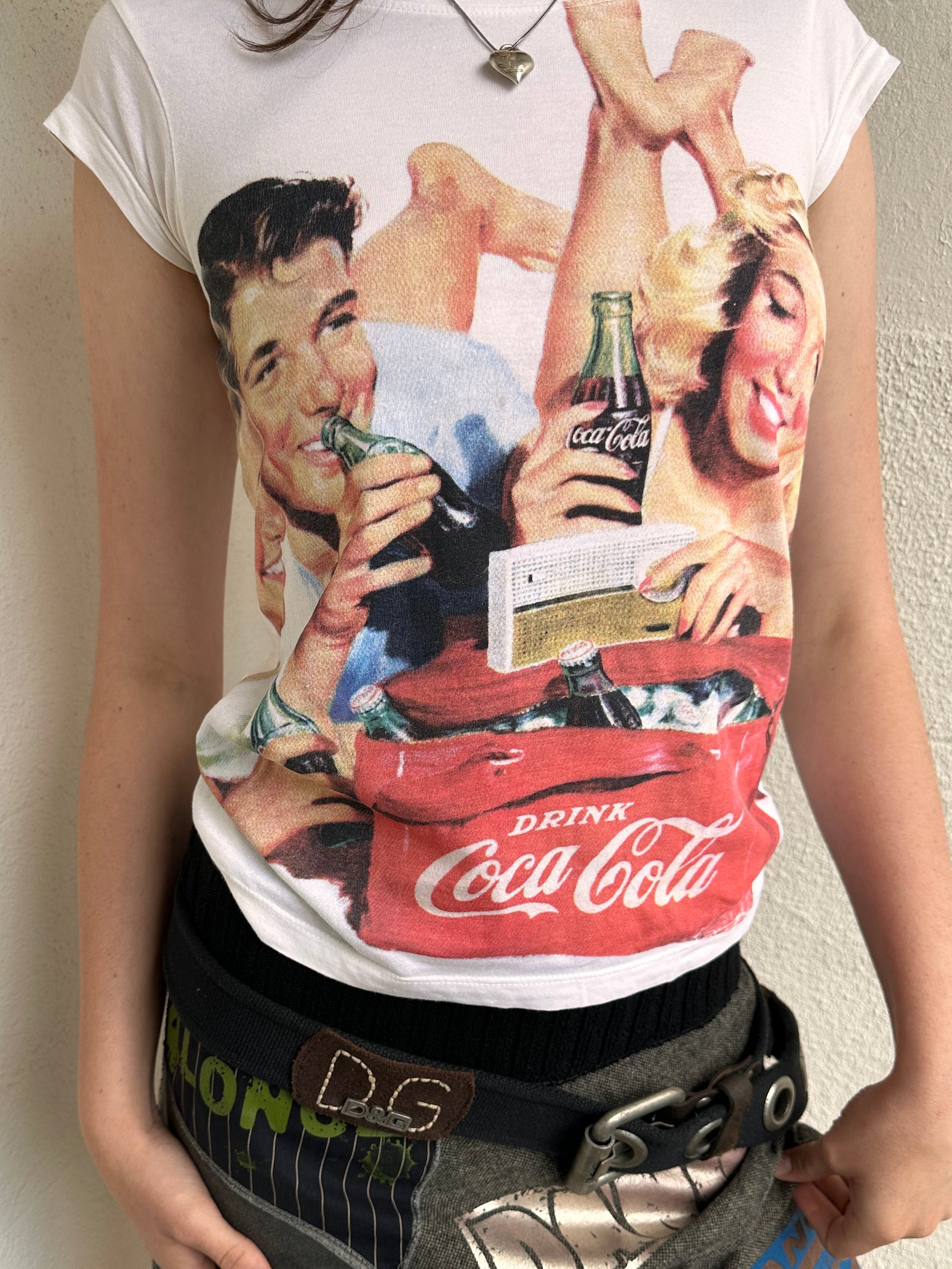 Woman wearing a Y2K 00s Coca Cola family print T-shirt
