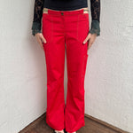 Woman wearing a Y2K 00s Cop copine red straight leg and low waited pants with cut out waistband and yellow embroidery 