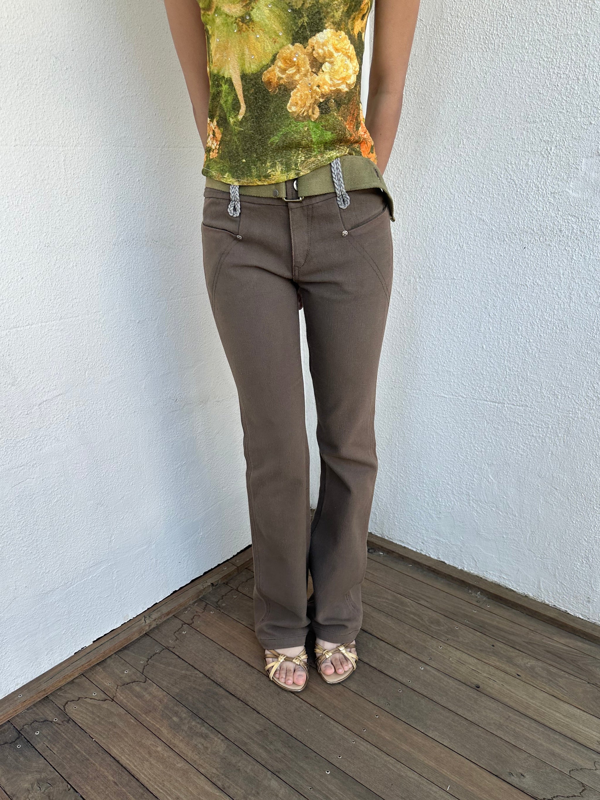 Woman wearing a Y2K 00s  Khaki flare  Jeans with attached utility belt 
