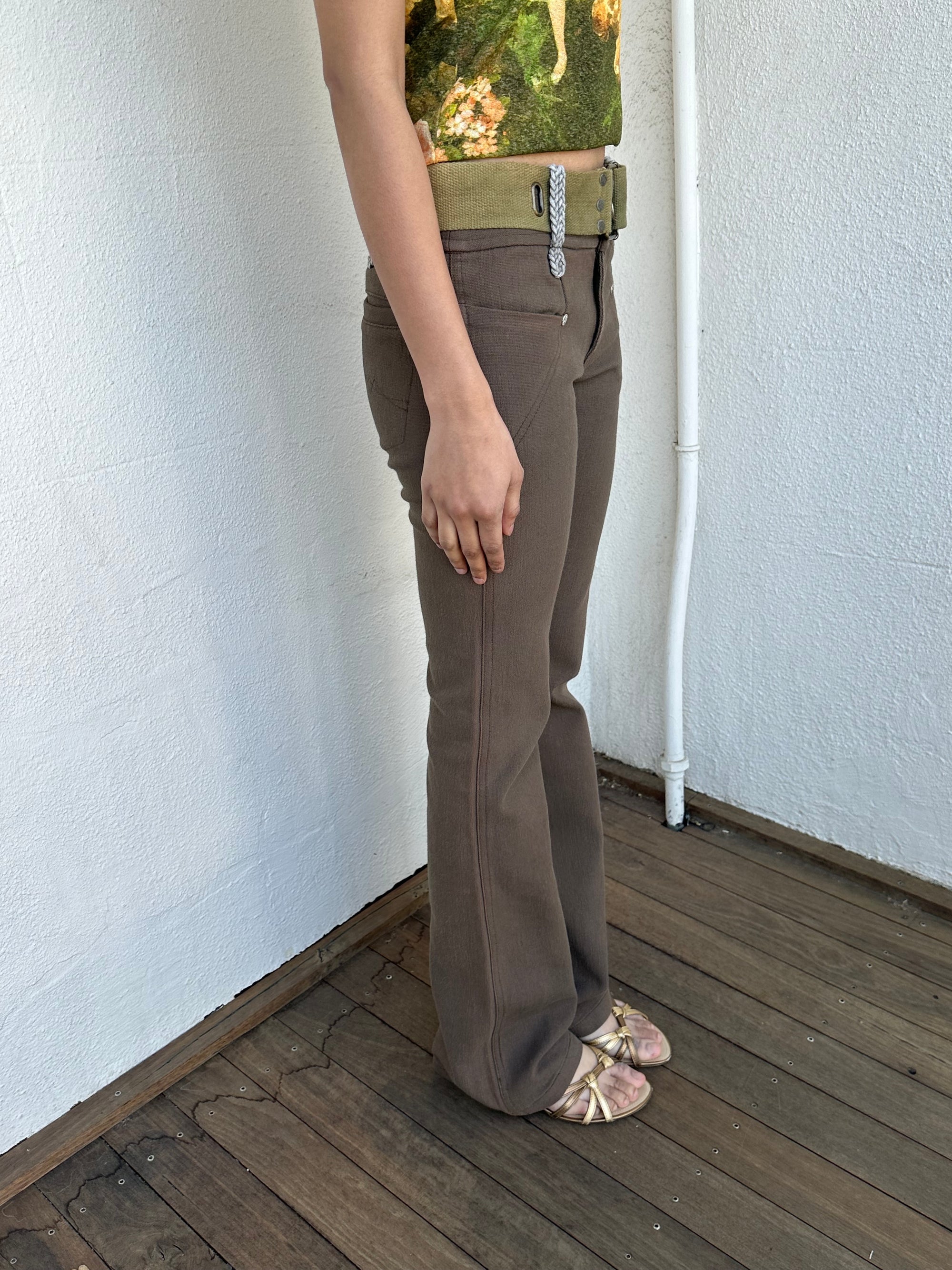 Woman wearing a Y2K 00s  Khaki flare  Jeans with attached utility belt 
