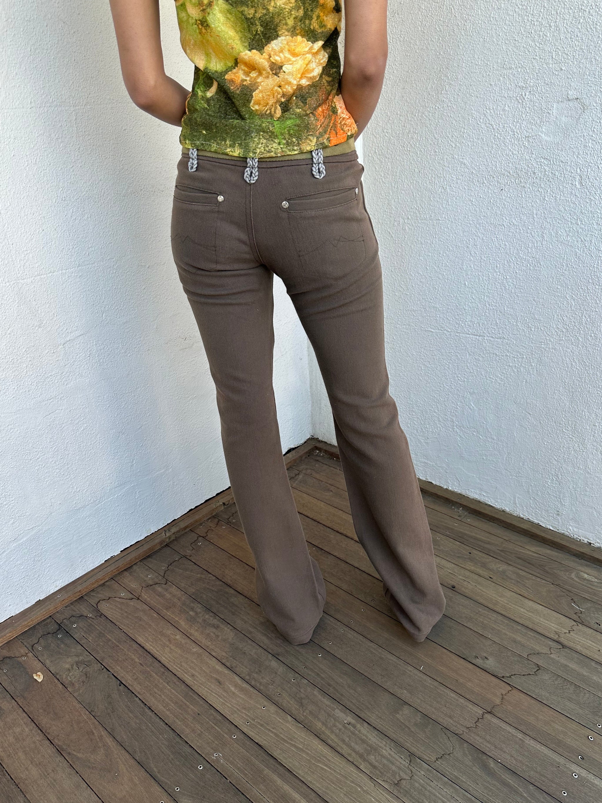 Woman wearing a Y2K 00s  Khaki flare  Jeans with attached utility belt 