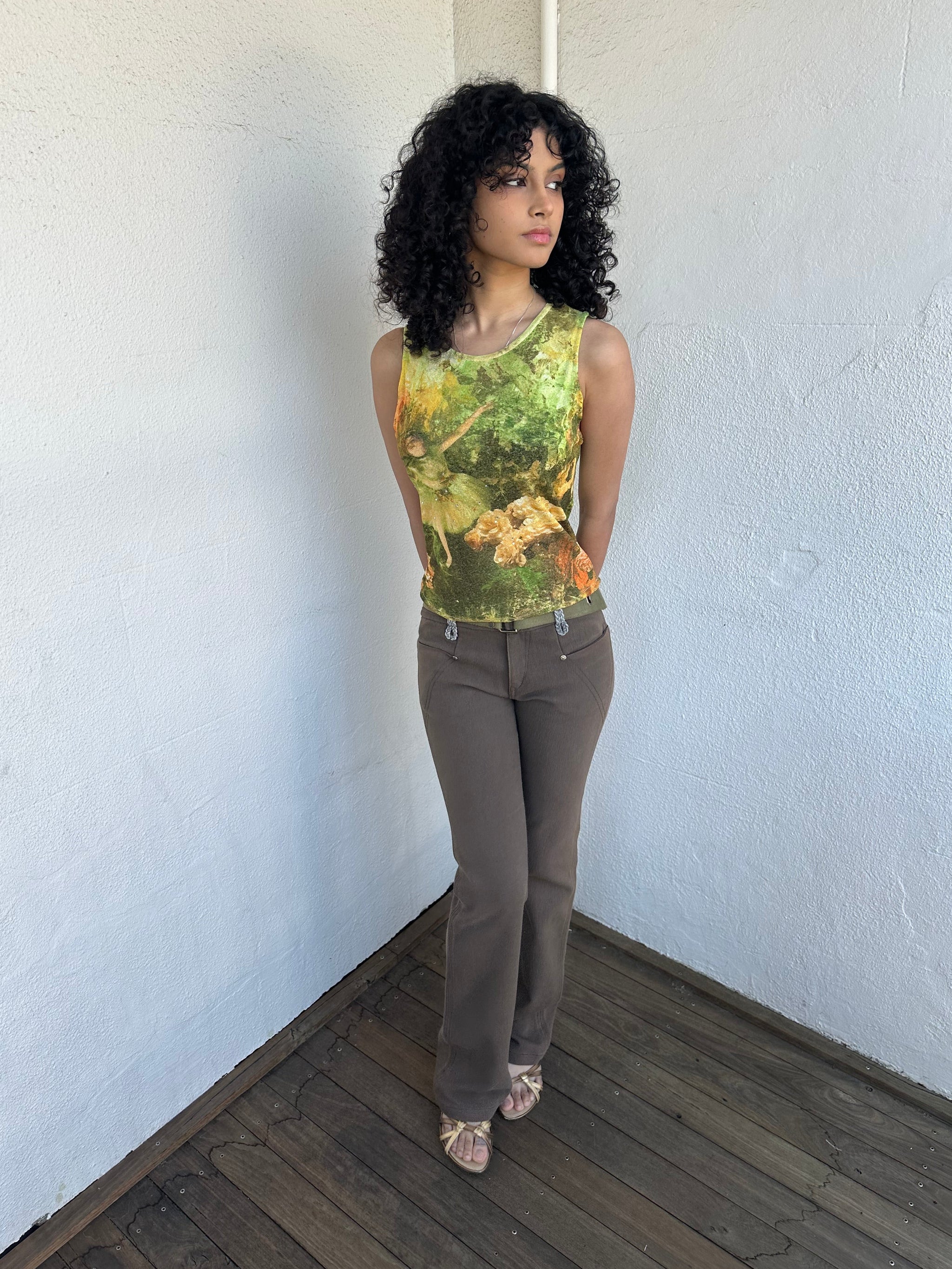 Woman wearing a Y2K 00s  Khaki flare  Jeans with attached utility belt 
