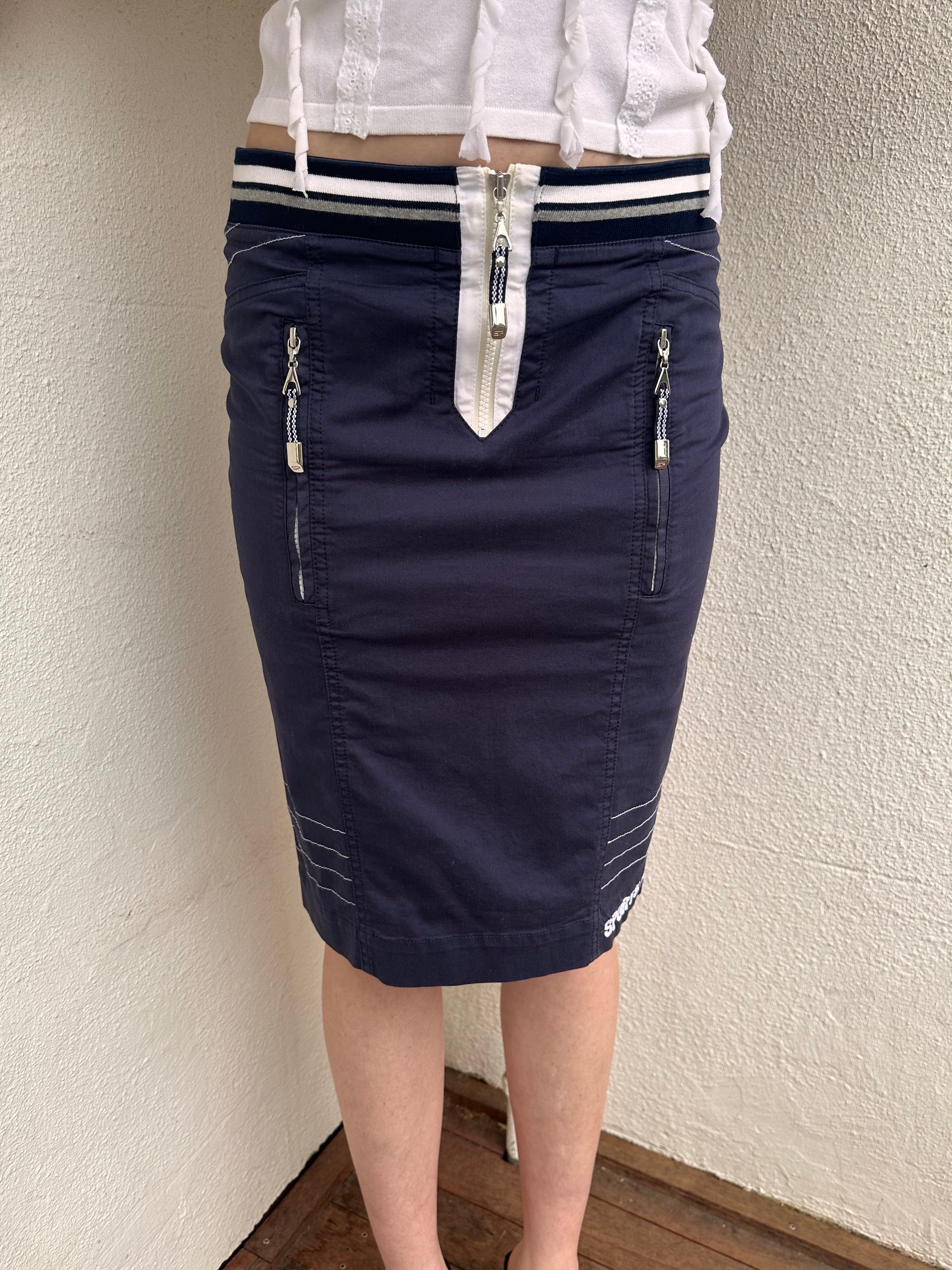 Woman wearing a Y2K 00s sportalm navy and white sporty midi skirt 