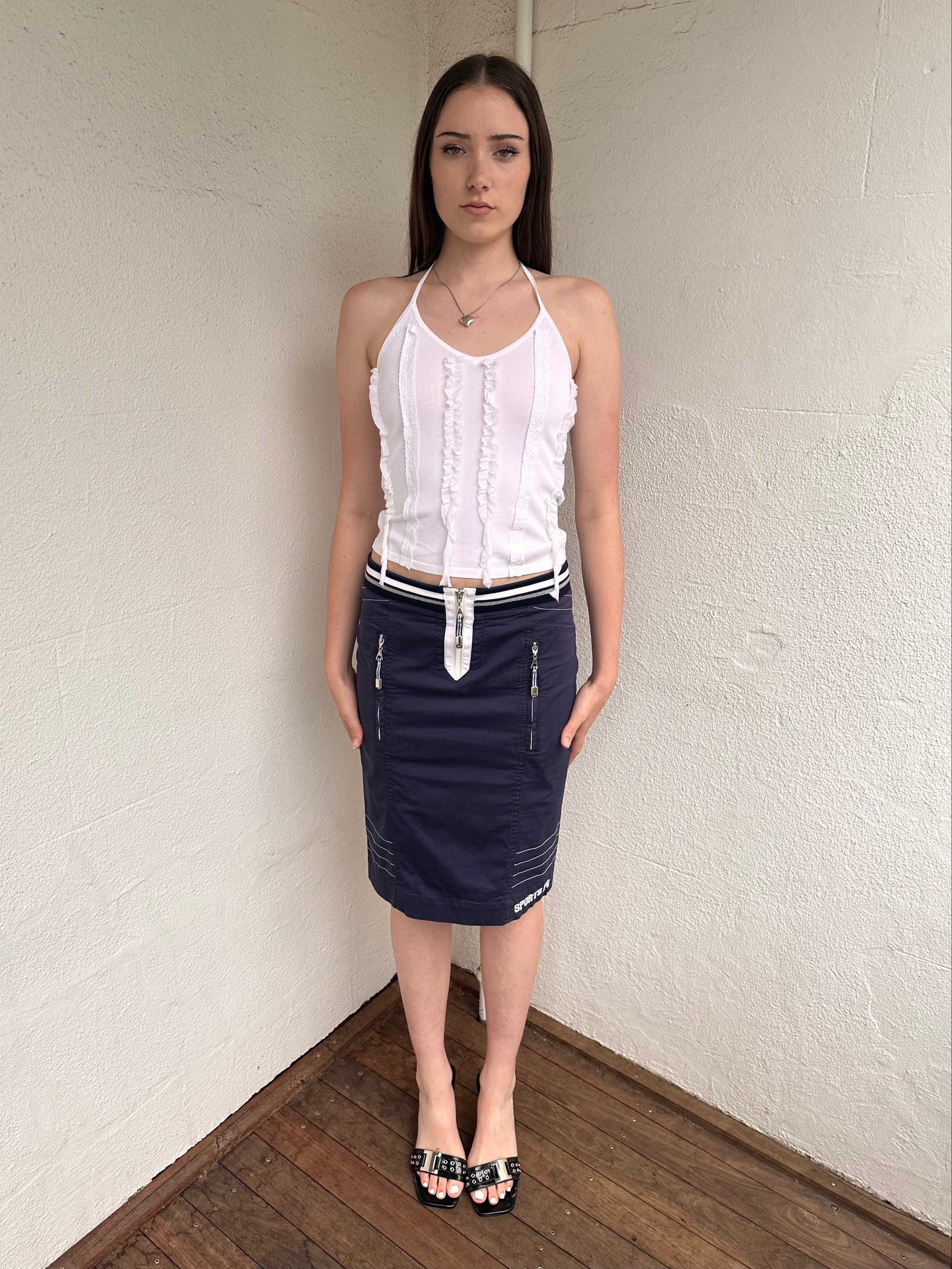 Woman wearing a Y2K 00s sportalm navy and white sporty midi skirt 
