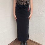 Woman wearing a Y2K 00s pimkie Y2K black with Chinese red embroidered details maxi skirt 