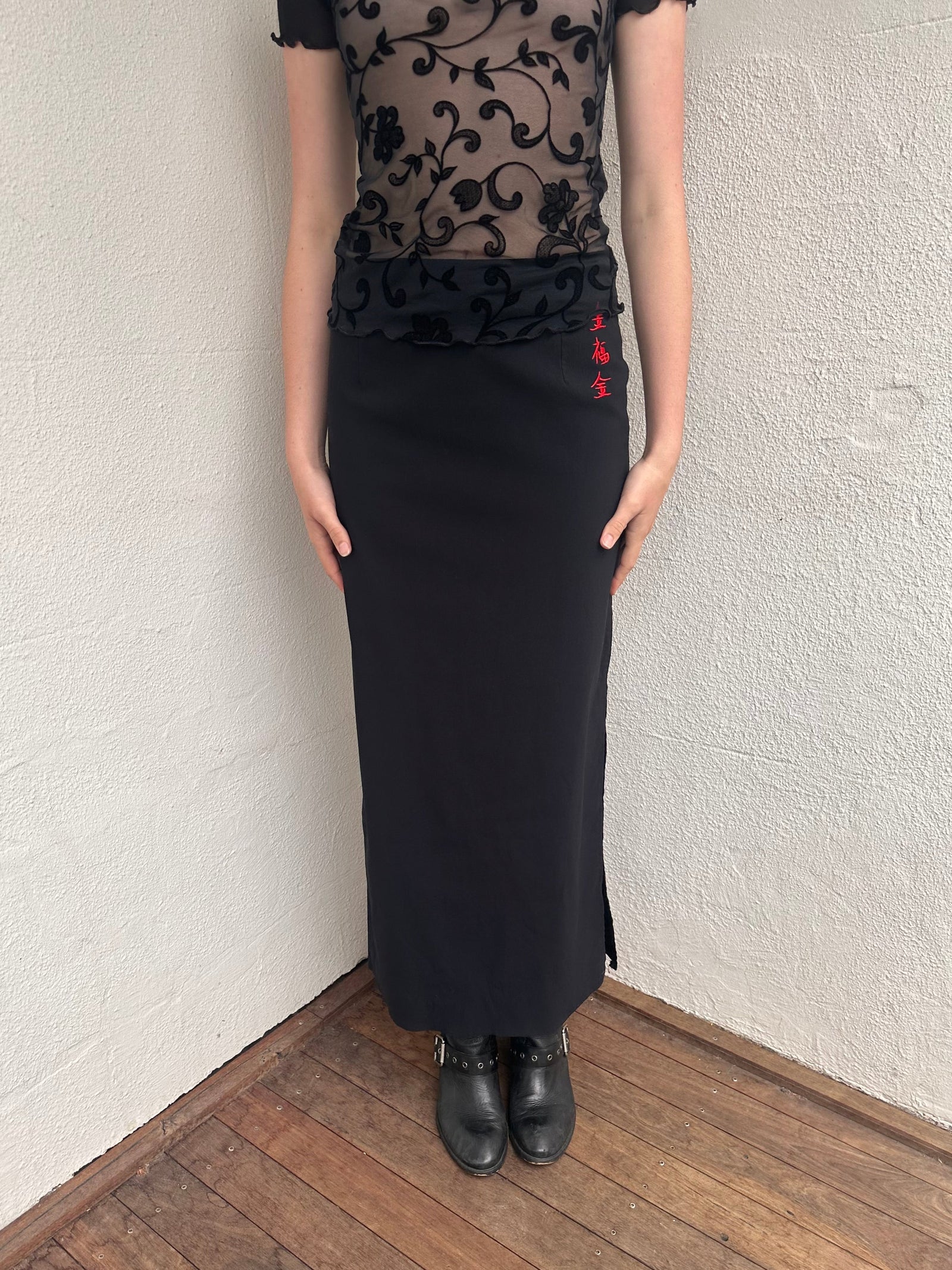 Woman wearing a Y2K 00s pimkie Y2K black with Chinese red embroidered details maxi skirt 