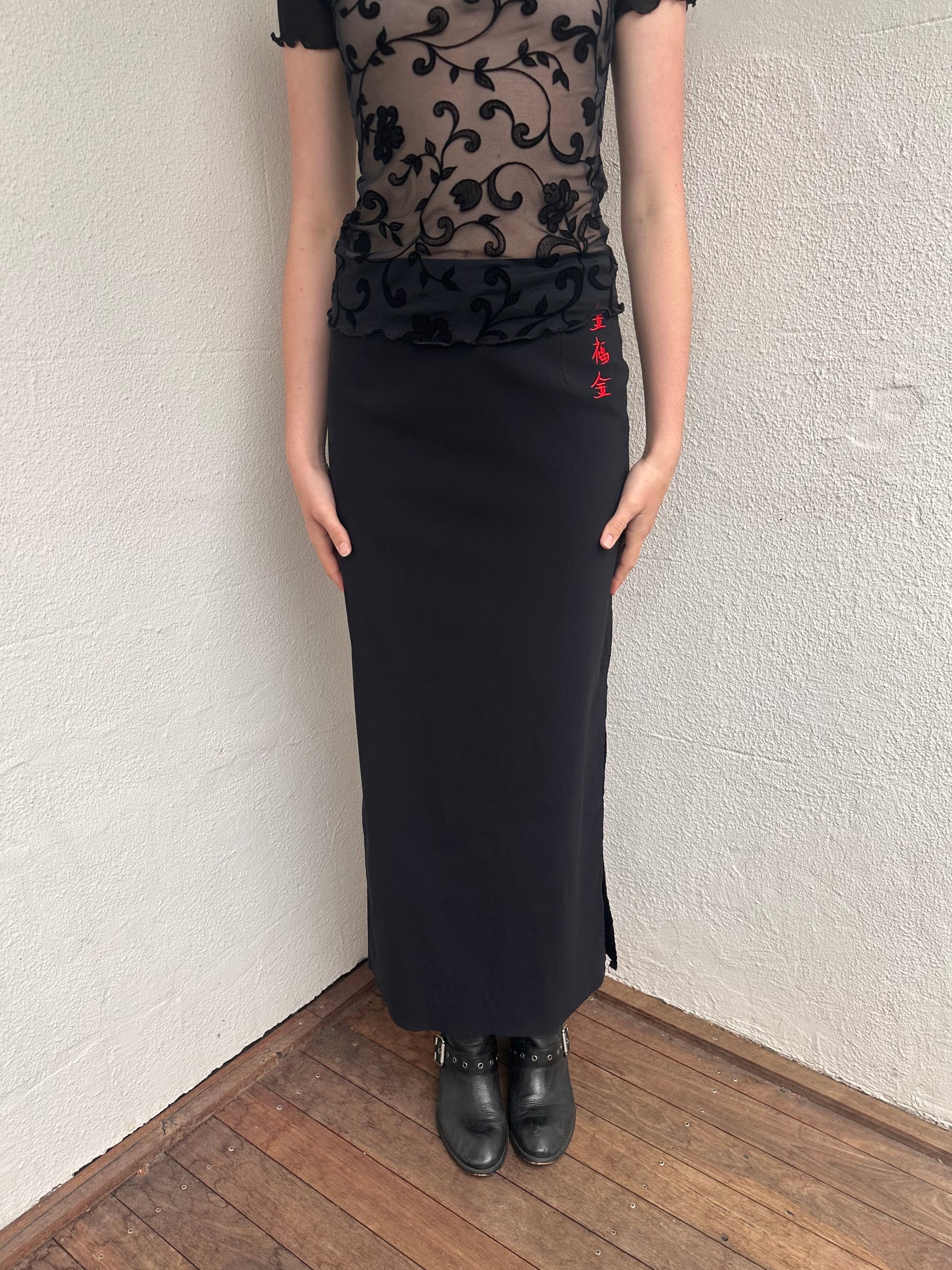 Woman wearing a Y2K 00s pimkie Y2K black with Chinese red embroidered details maxi skirt 