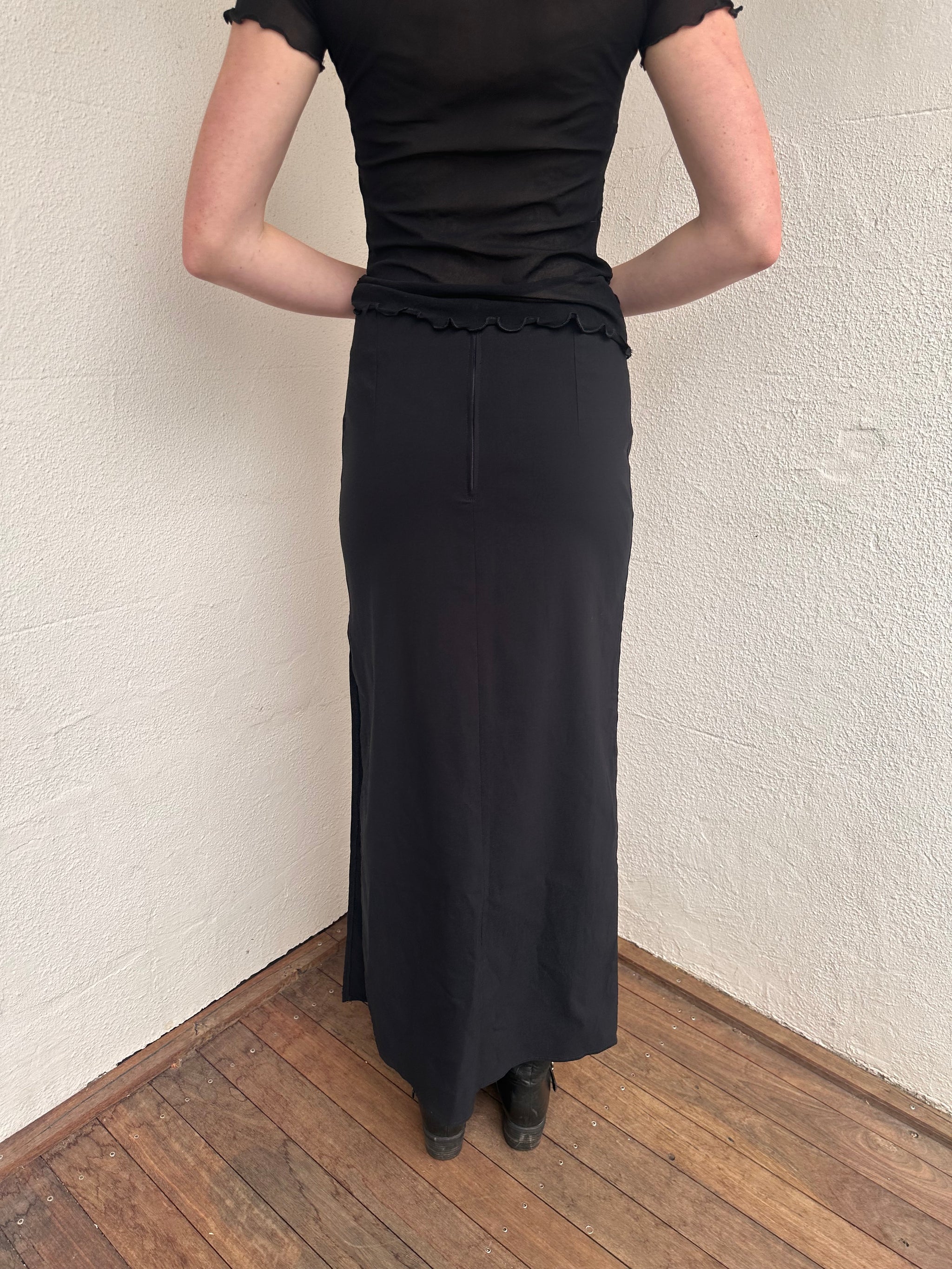 Woman wearing a Y2K 00s pimkie Y2K black with Chinese red embroidered details maxi skirt 
