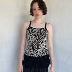 Woman Dressed in Y2K Animal print rhinestone top featuring a cream and brown zebra-style patterned body with rhinestone embellishment throughout.