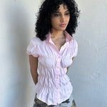 Women wearing a 00s Y2K Baby pink reworked cinched shirt featuring gathered detailing at the waist for a fitted silhouette.