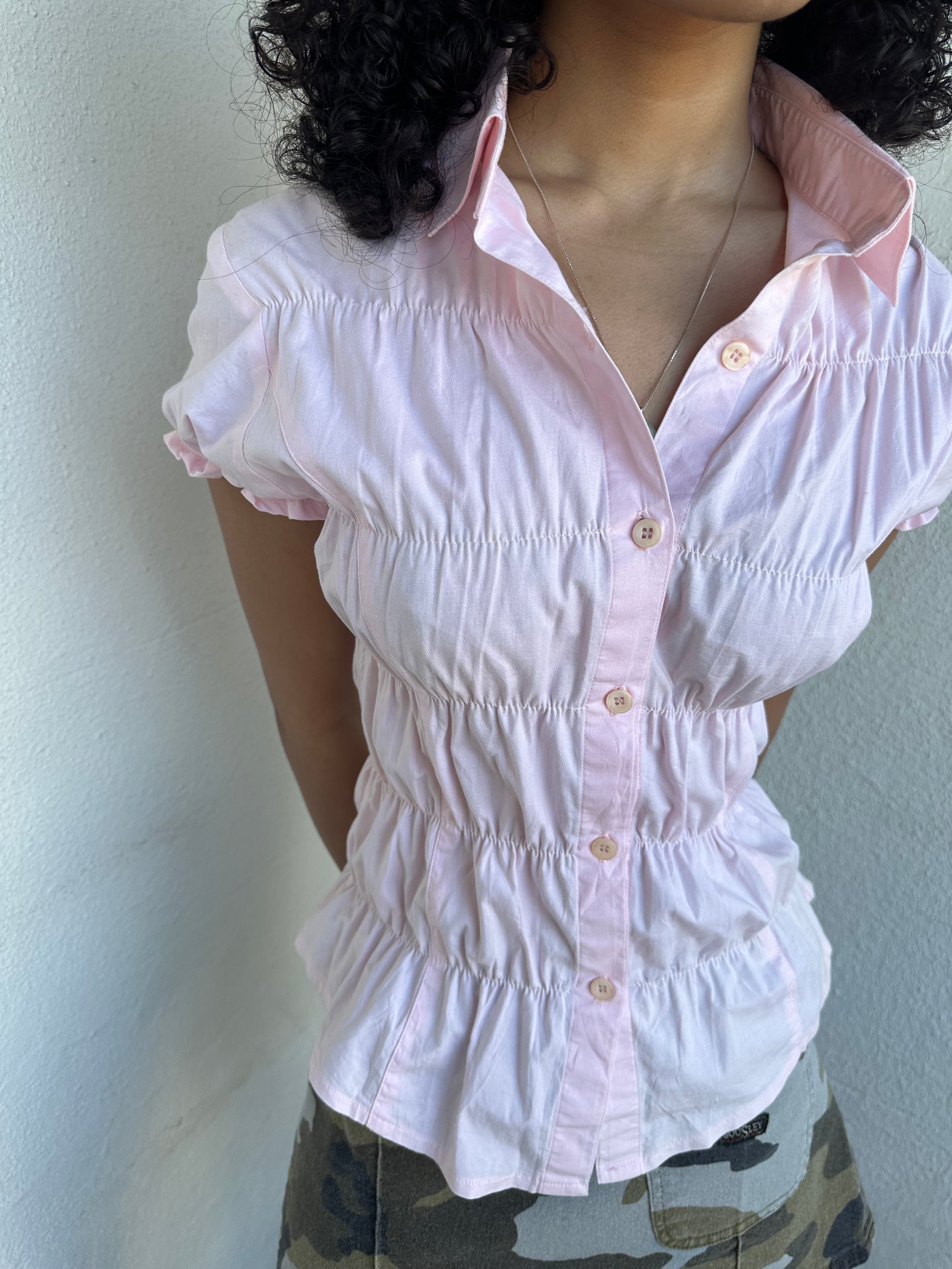 Women wearing a 00s Y2K Baby pink reworked cinched shirt featuring gathered detailing at the waist for a fitted silhouette.