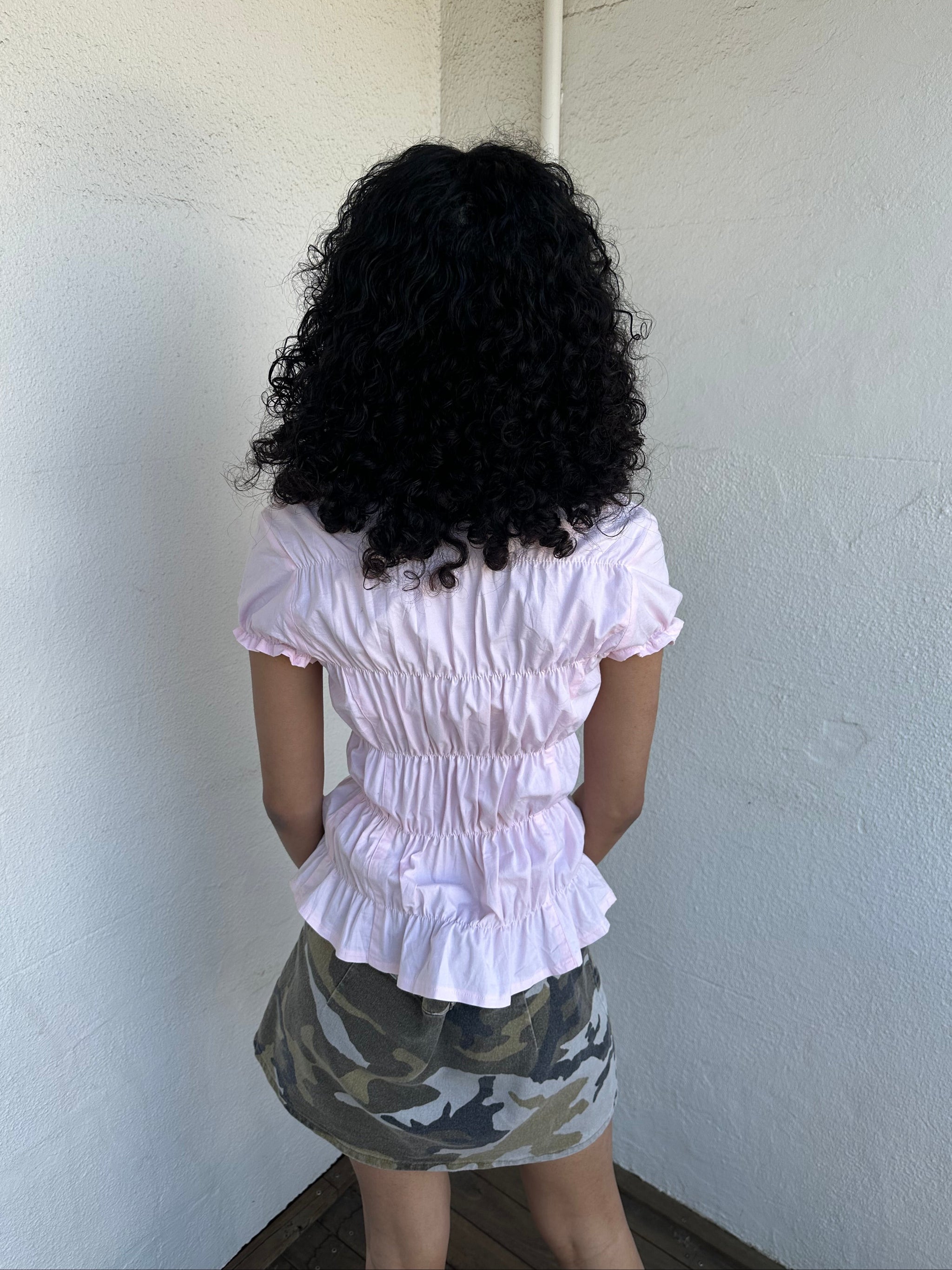 Women wearing a 00s Y2K Baby pink reworked cinched shirt featuring gathered detailing at the waist for a fitted silhouette.