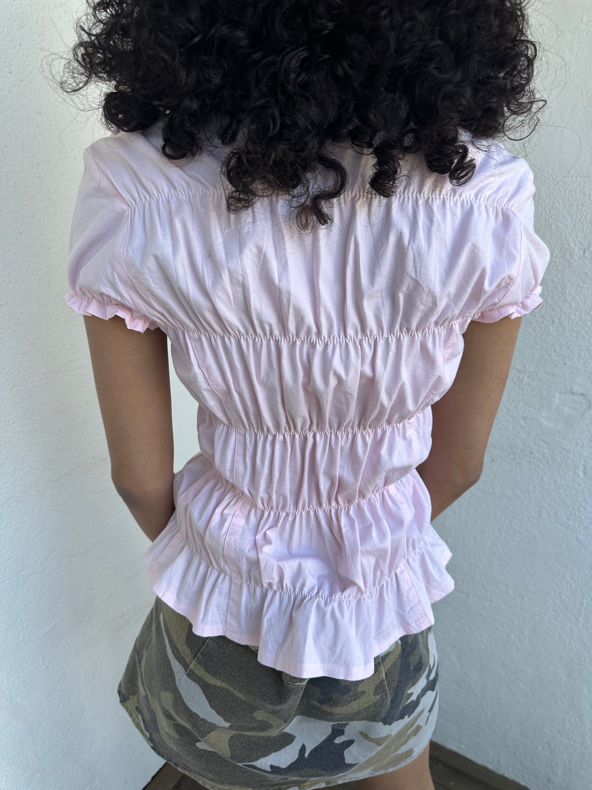 Women wearing a 00s Y2K Baby pink reworked cinched shirt featuring gathered detailing at the waist for a fitted silhouette.