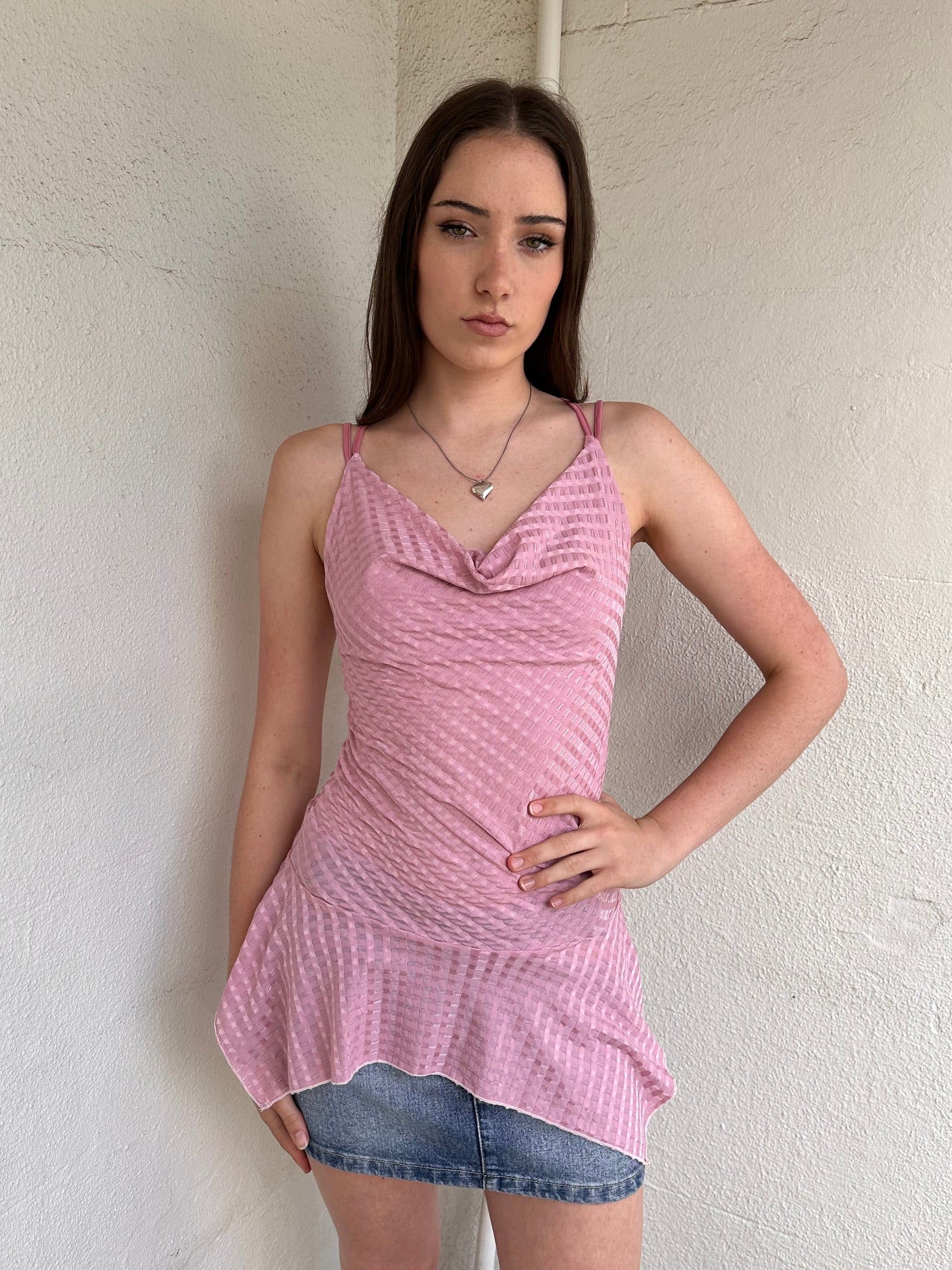 Woman wearing a Y2K 00s Baby pink cowlneck top featuring a soft draped neckline with criss-cross strap detailing 