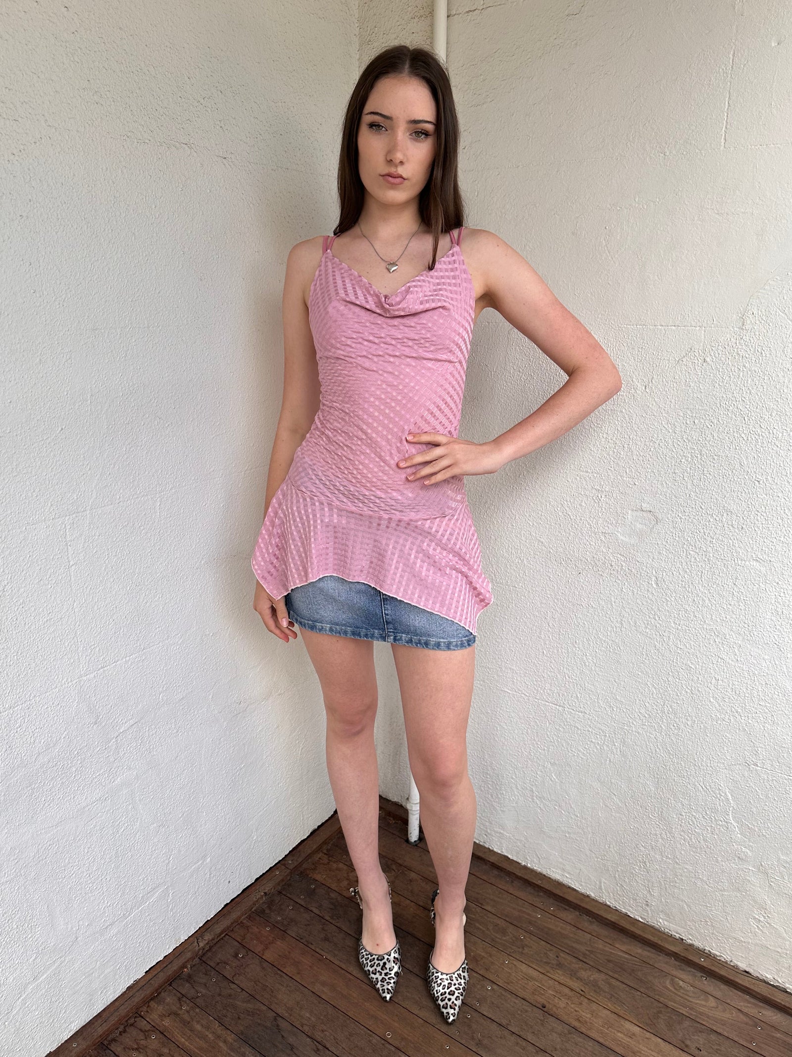 Woman wearing a Y2K 00s Baby pink cowlneck top featuring a soft draped neckline with criss-cross strap detailing 