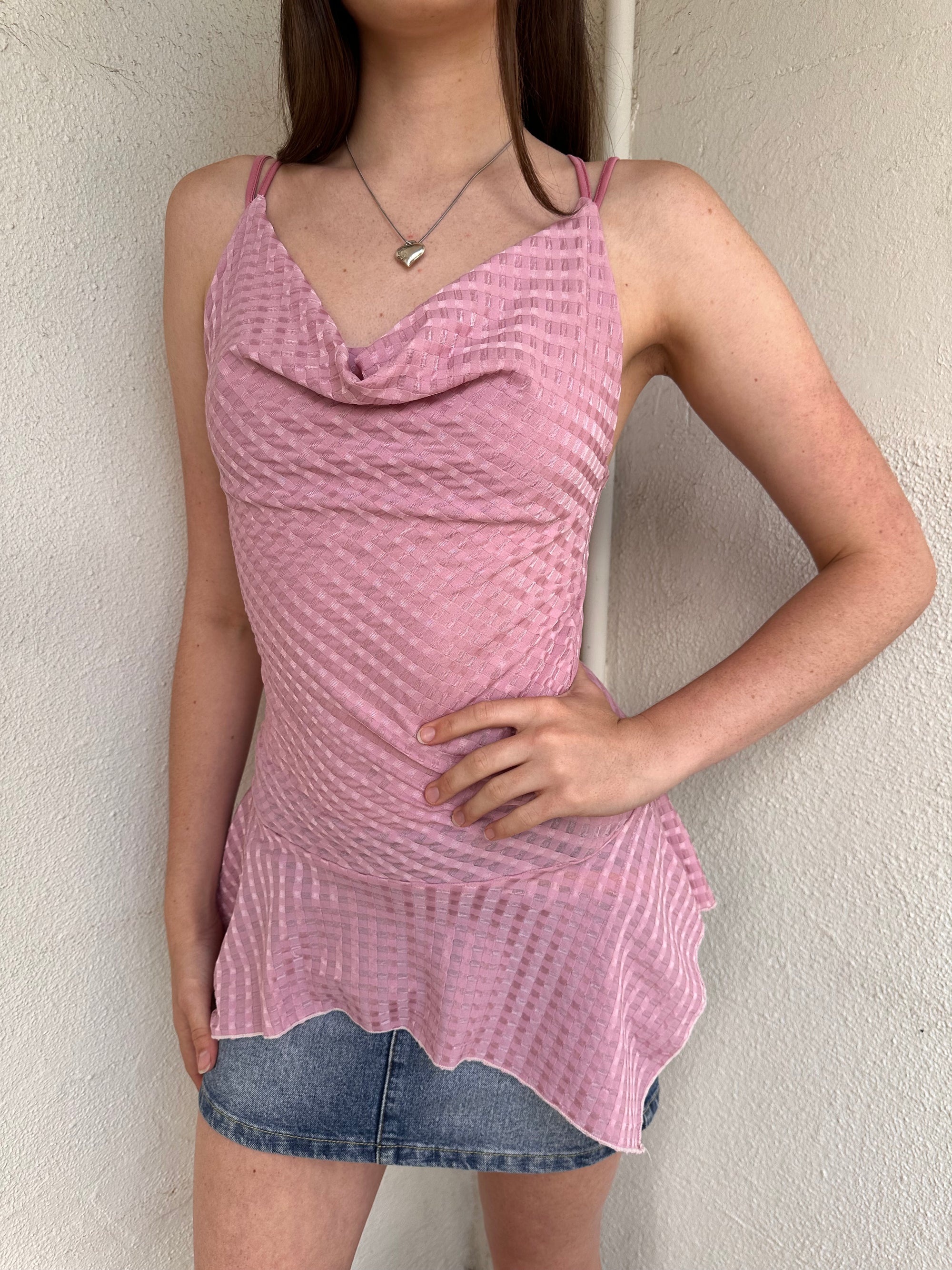 Woman wearing a Y2K 00s Baby pink cowlneck top featuring a soft draped neckline with criss-cross strap detailing 