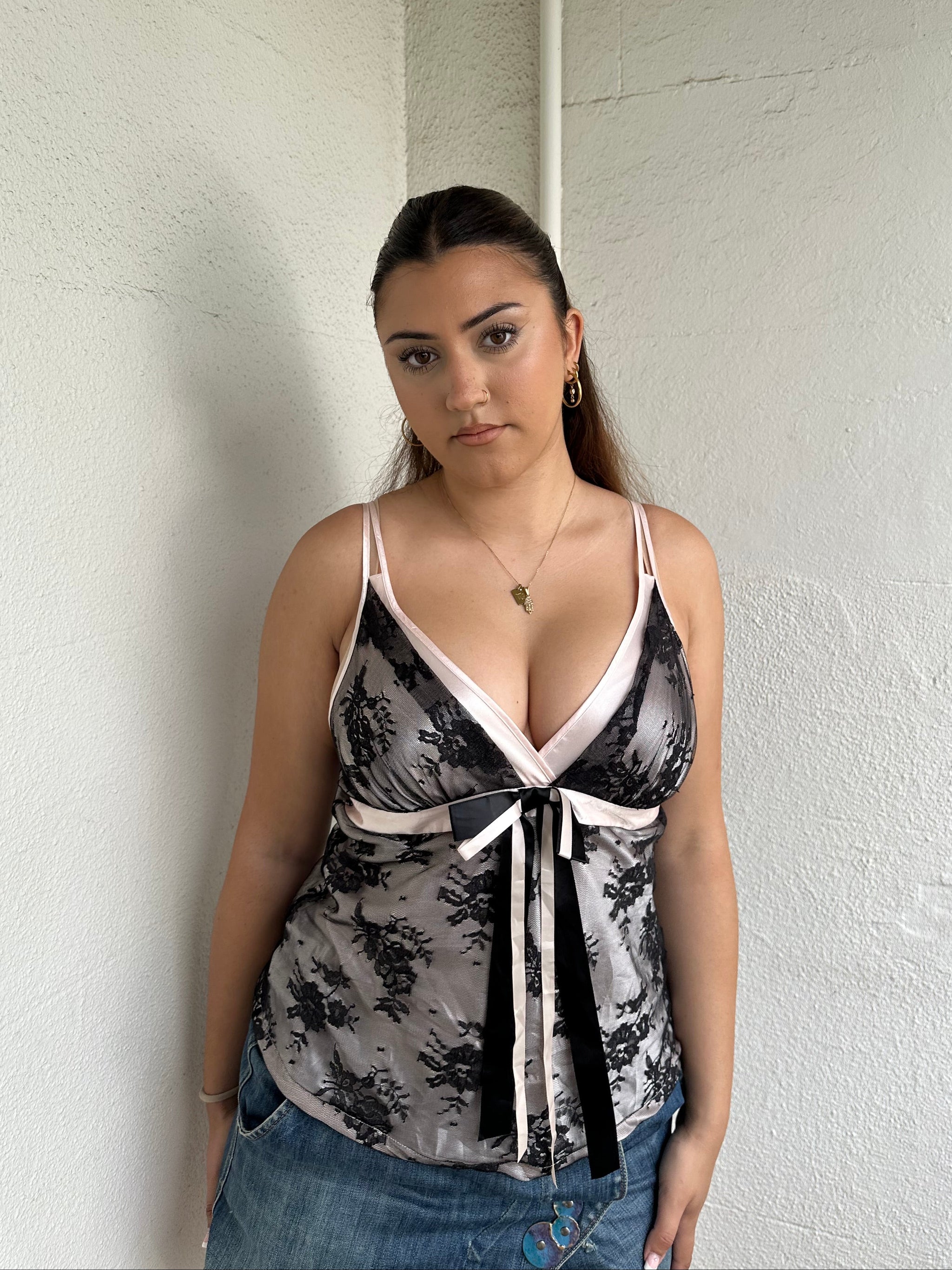 Woman Dressed in Y2K 00s Baby pink satin and black lace cami 
