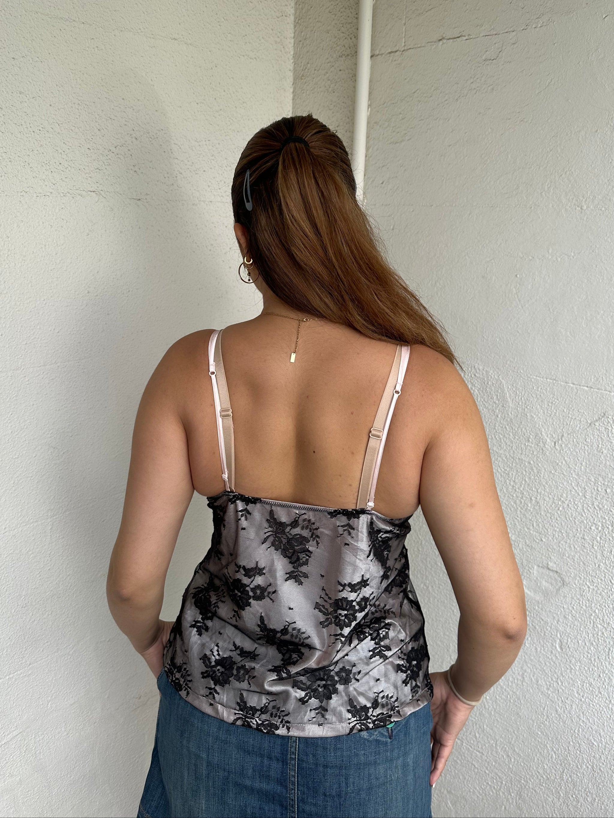 Woman Dressed in Y2K 00s Baby pink satin and black lace cami 