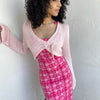 Woman wearing a Y2K 00s Baby Pink Bolero Cropped Cardigan. 