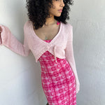 Woman wearing a Y2K 00s Baby Pink Bolero Cropped Cardigan. 