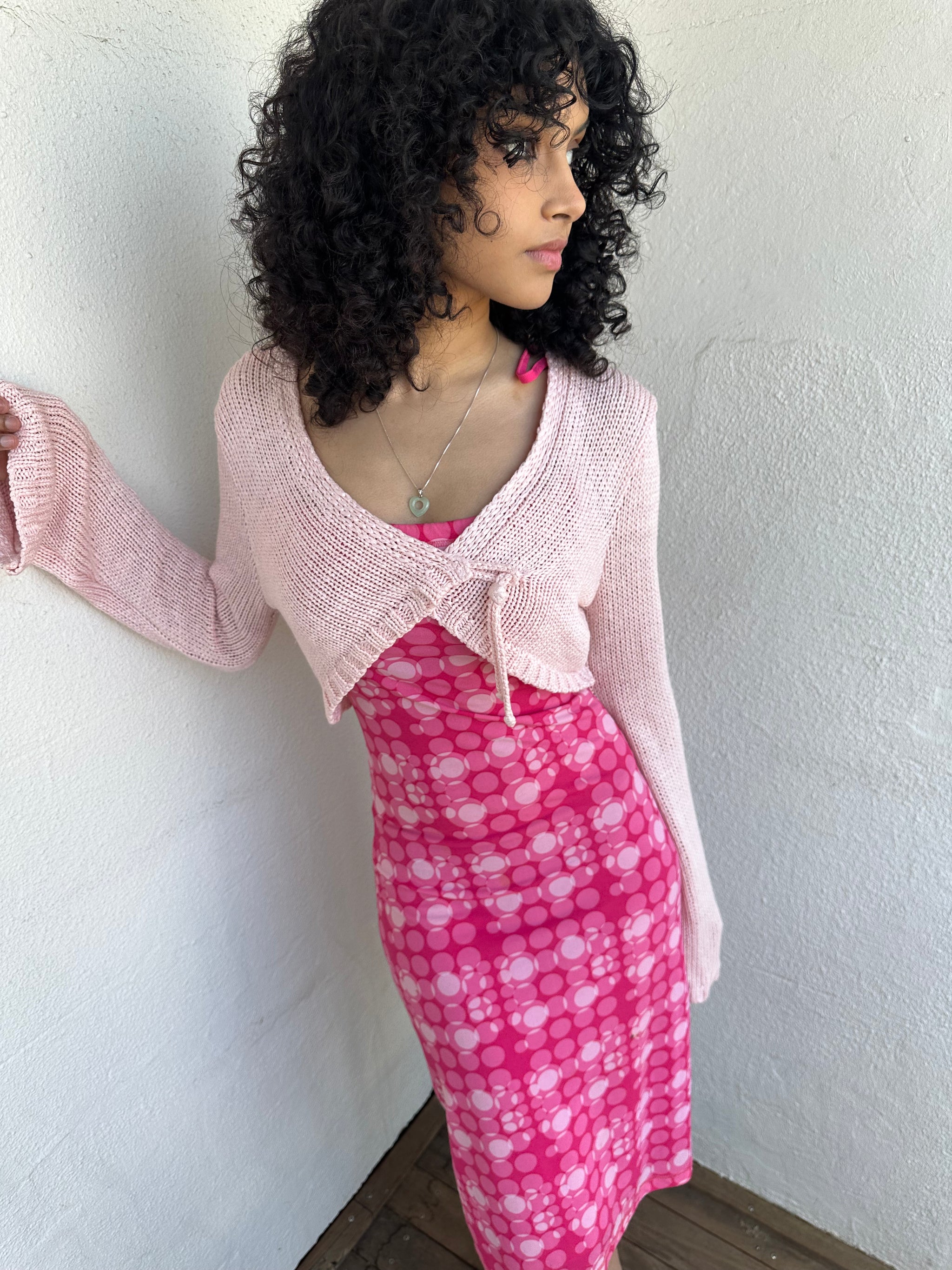 Woman wearing a Y2K 00s Baby Pink Bolero Cropped Cardigan. 