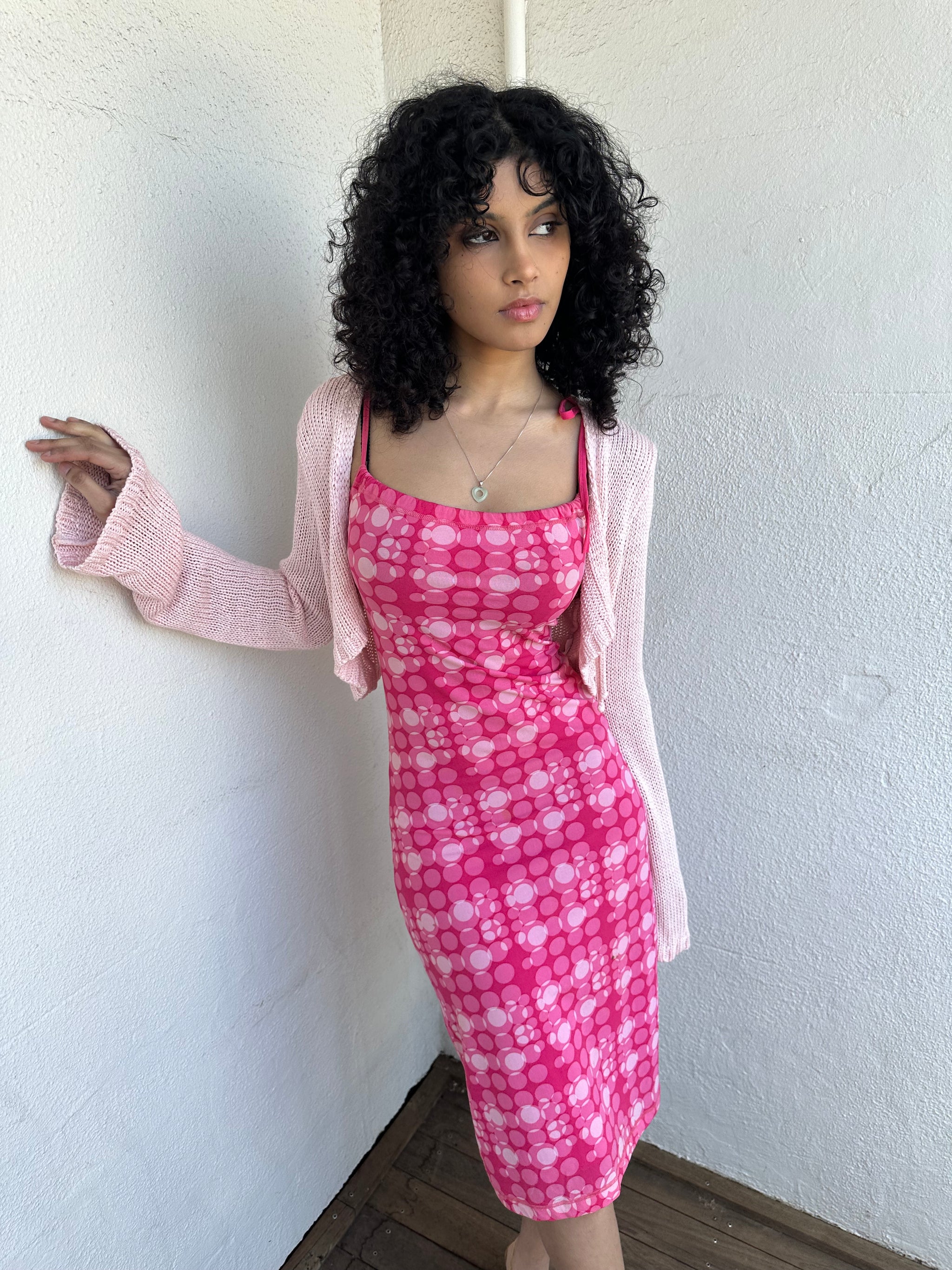 Woman wearing a Y2K 00s Baby Pink Bolero Cropped Cardigan. 