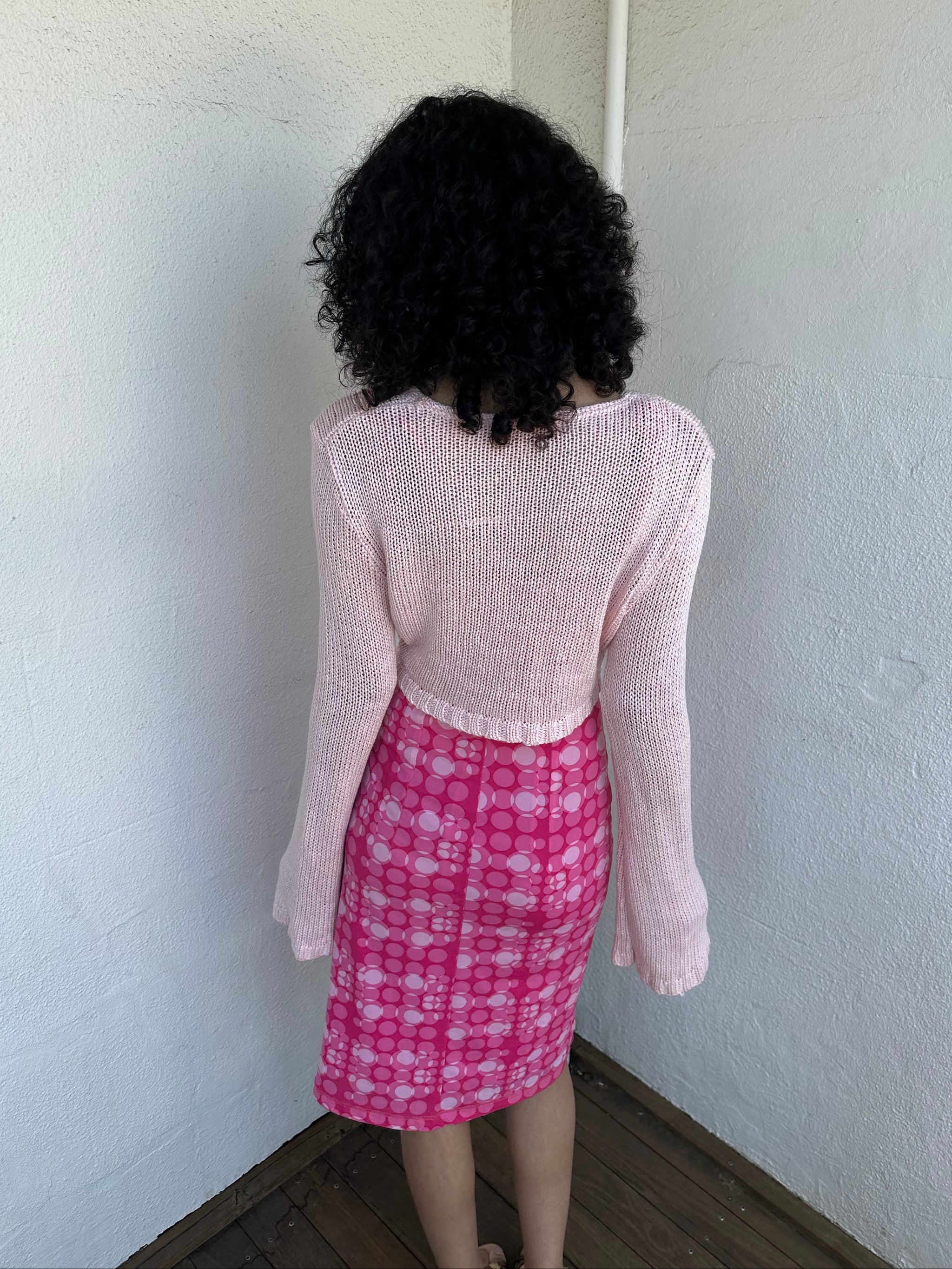 Woman wearing a Y2K 00s Baby Pink Bolero Cropped Cardigan. 