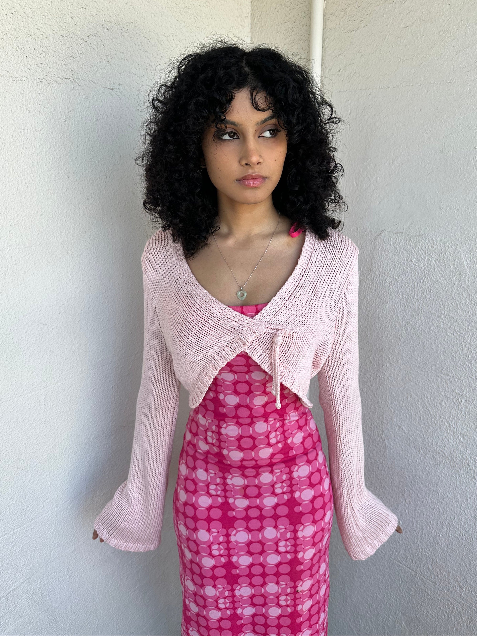 Woman wearing a Y2K 00s Baby Pink Bolero Cropped Cardigan. 