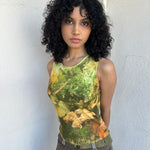 Woman wearing a Y2K 90sBallerina painting yellow and green mesh tank top.