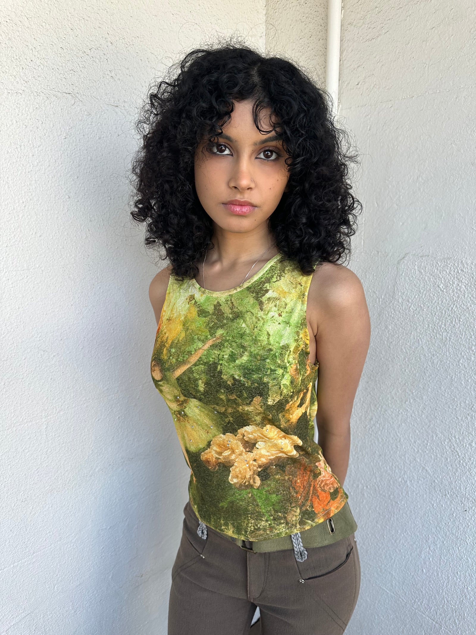 Woman wearing a Y2K 90sBallerina painting yellow and green mesh tank top.