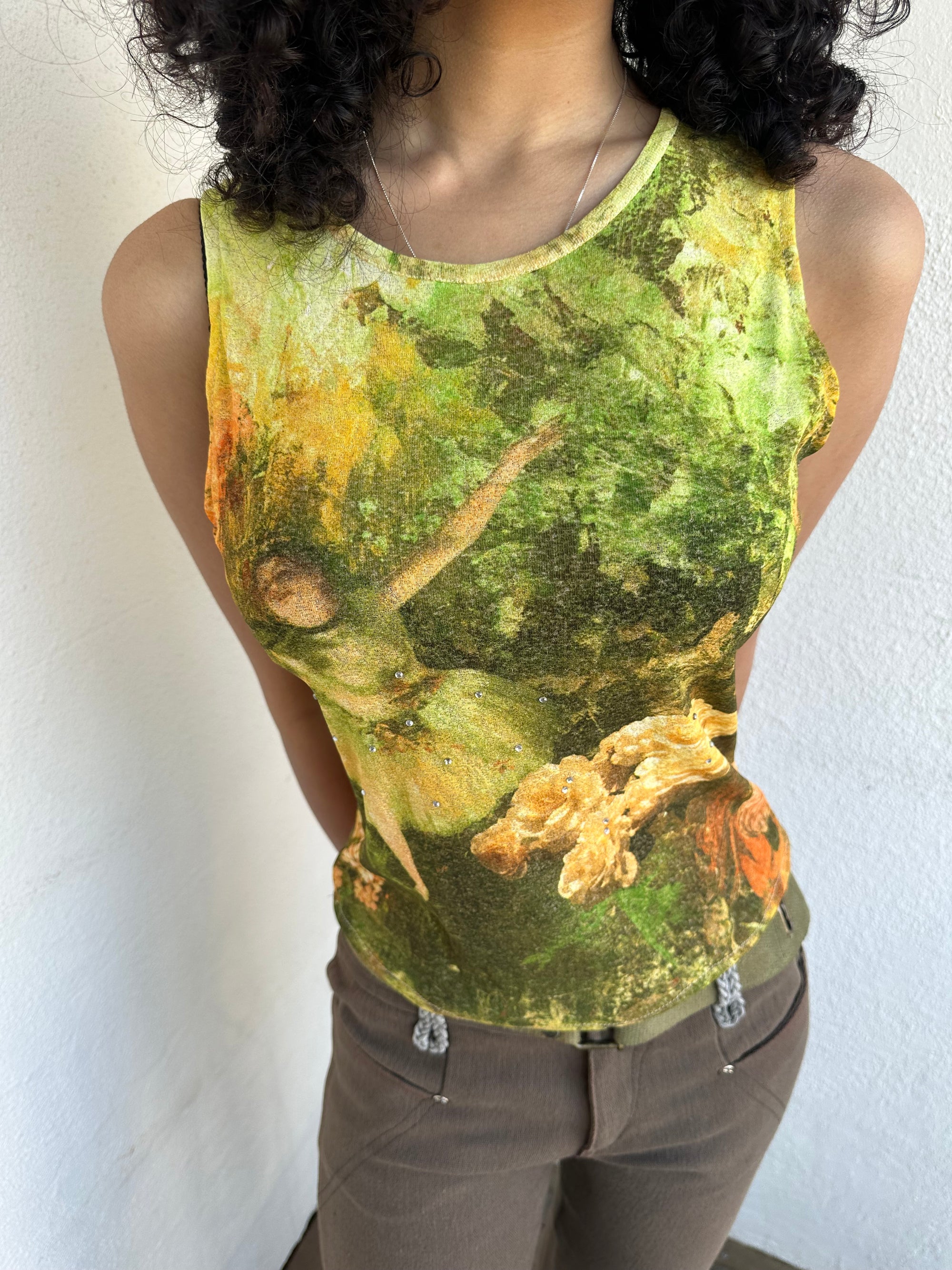 Woman wearing a Y2K 90sBallerina painting yellow and green mesh tank top.