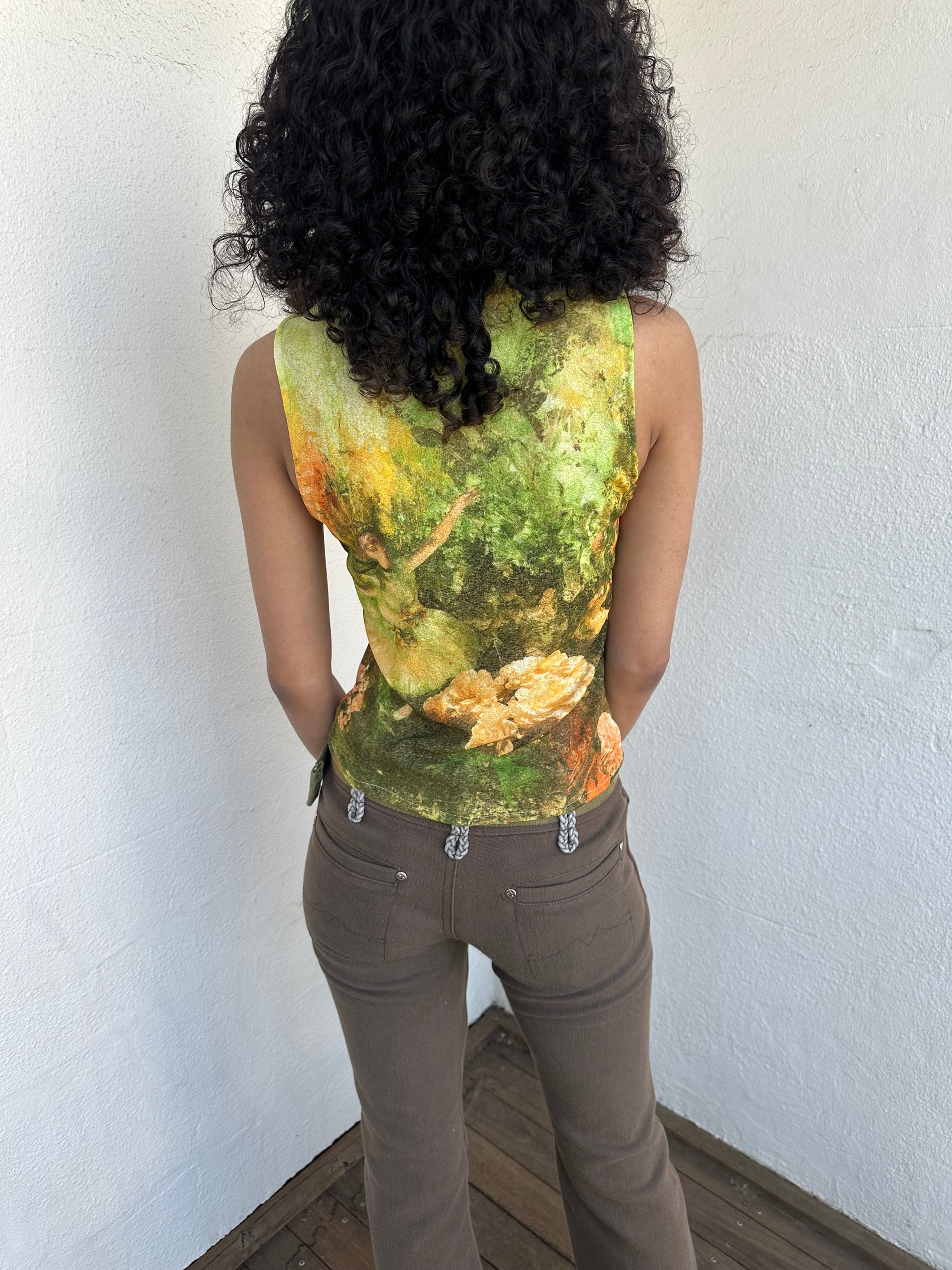 Woman wearing a Y2K 90sBallerina painting yellow and green mesh tank top.