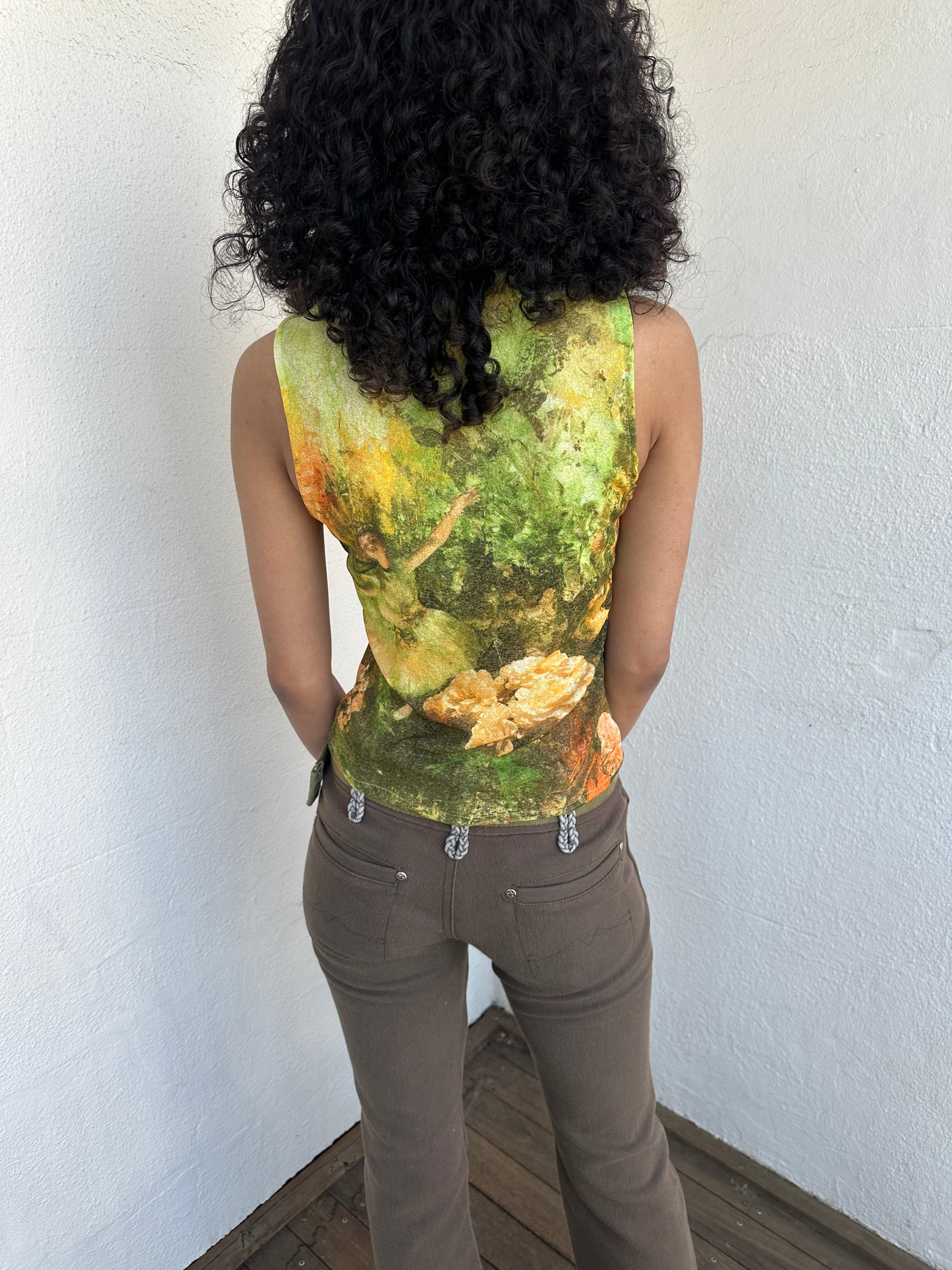 Woman wearing a Y2K 90sBallerina painting yellow and green mesh tank top.