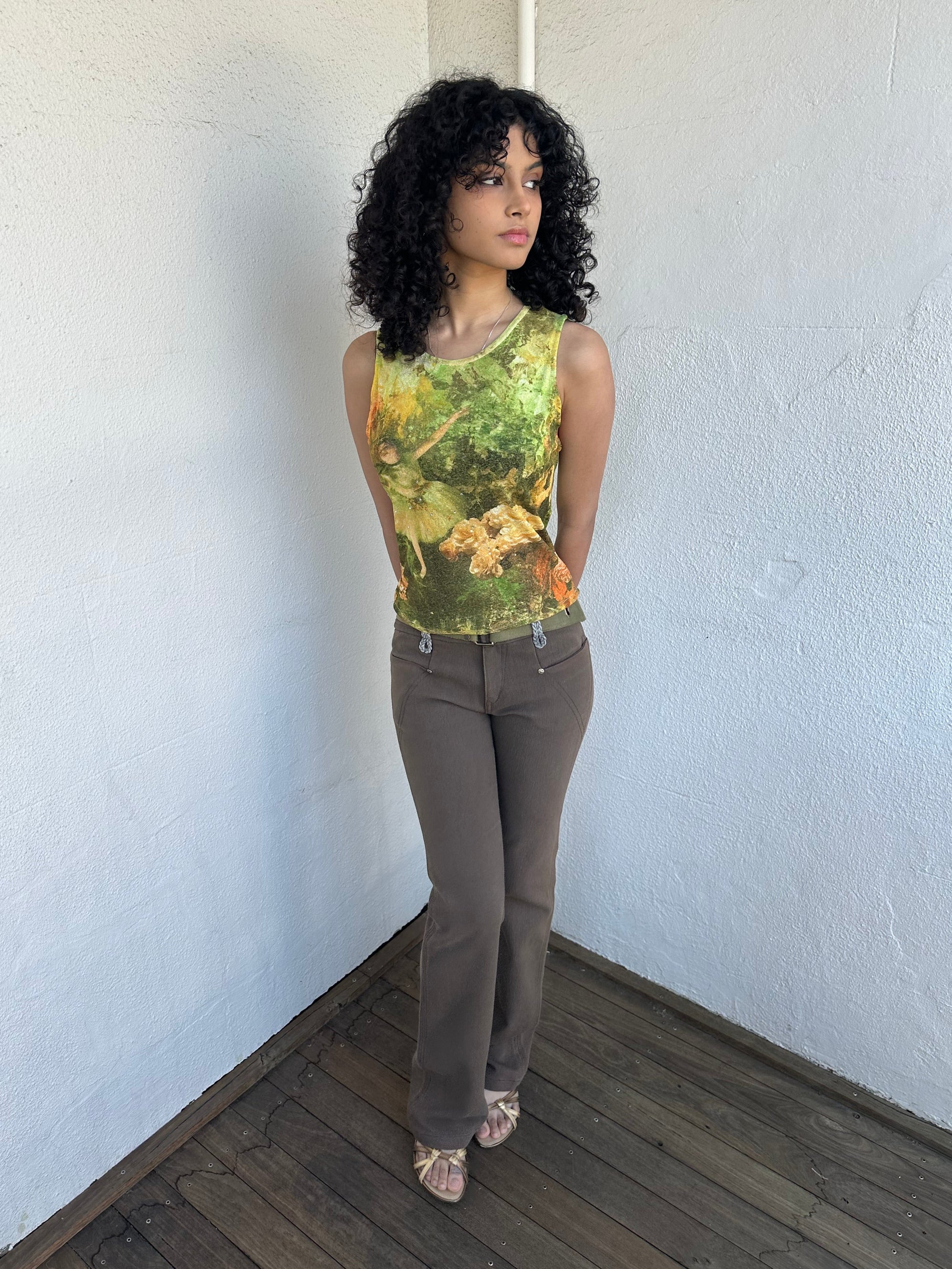 Woman wearing a Y2K 90sBallerina painting yellow and green mesh tank top.