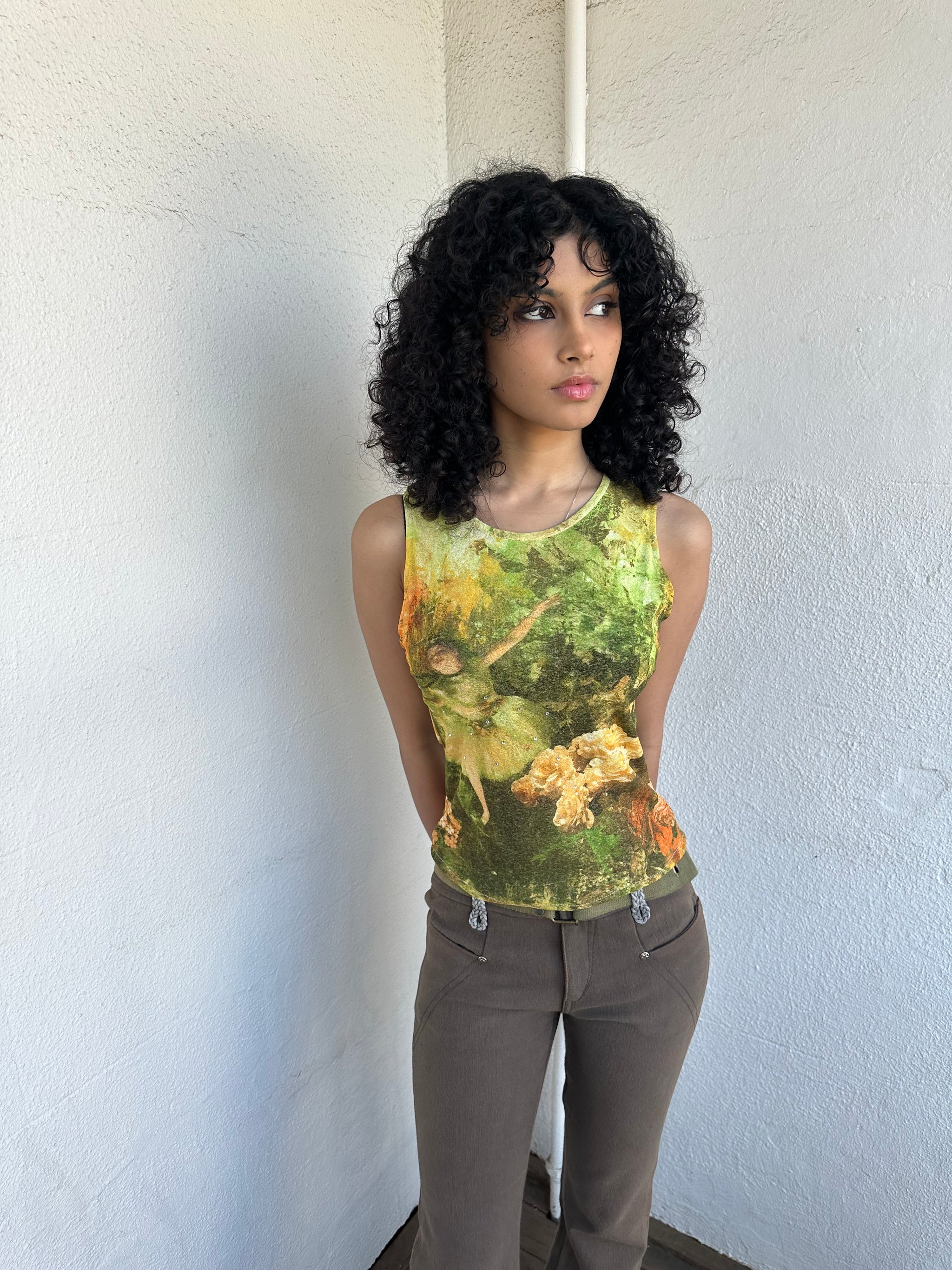 Woman wearing a Y2K 90sBallerina painting yellow and green mesh tank top.