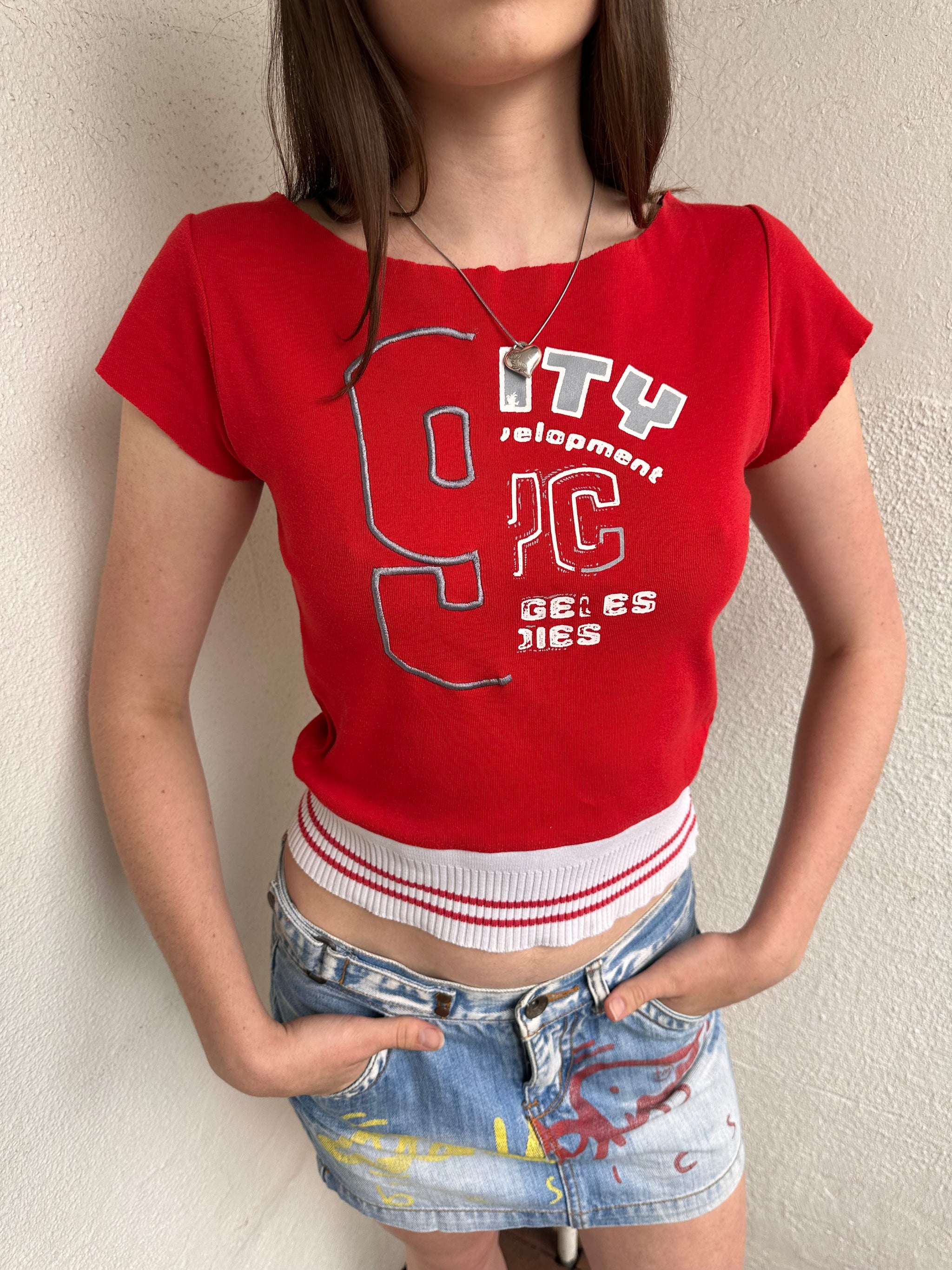 Women wearing a 00s Y2K Baseball-style red baby t-shirt with a wide neckline and white elasticated hem.