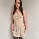 Women wearing a 00s Y2K Light beige boho layered mini dress with a flowy silhouette and soft textured fabric.
